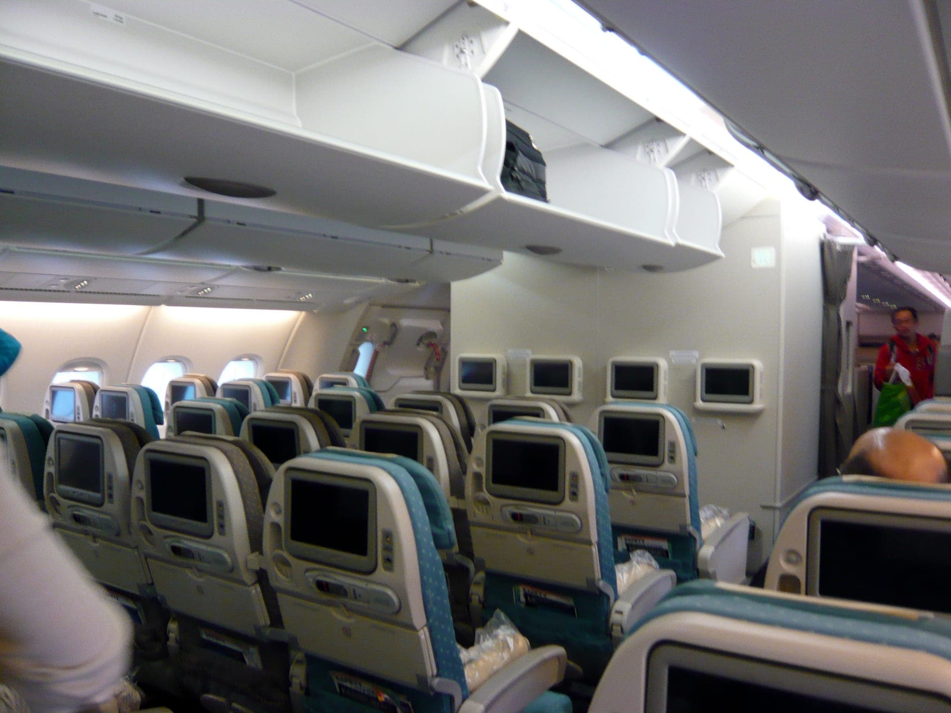 The economy cabin of an Airbus A380, ten-abreast seating on the main deck stretching toward the rear of the aircraft