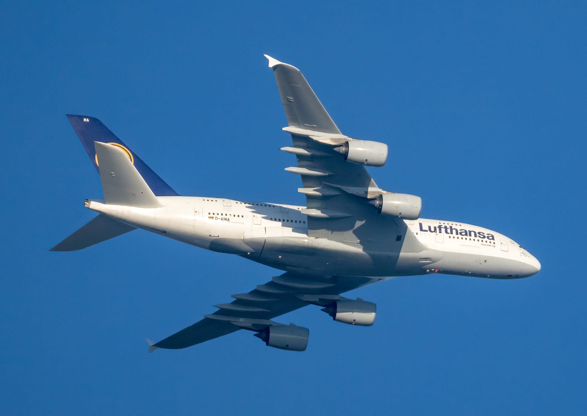 A Lufthansa Airbus A380-841, D-AIMA, seen in profile on the ground, the airline's crane emblem visible on the tail