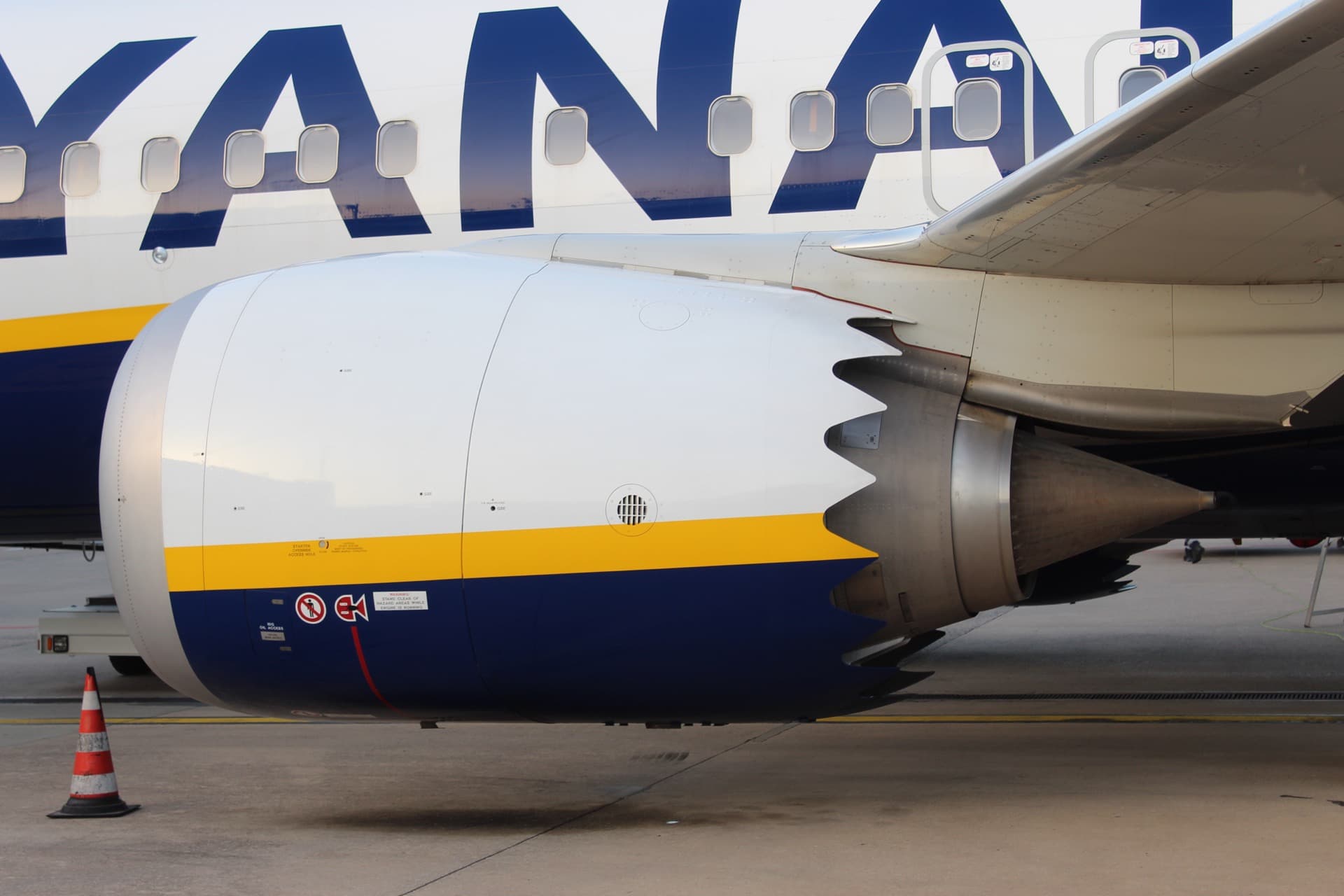 A CFM International LEAP-1B turbofan mounted beneath a Boeing 737 MAX wing, close up on the engine's large-diameter fan case