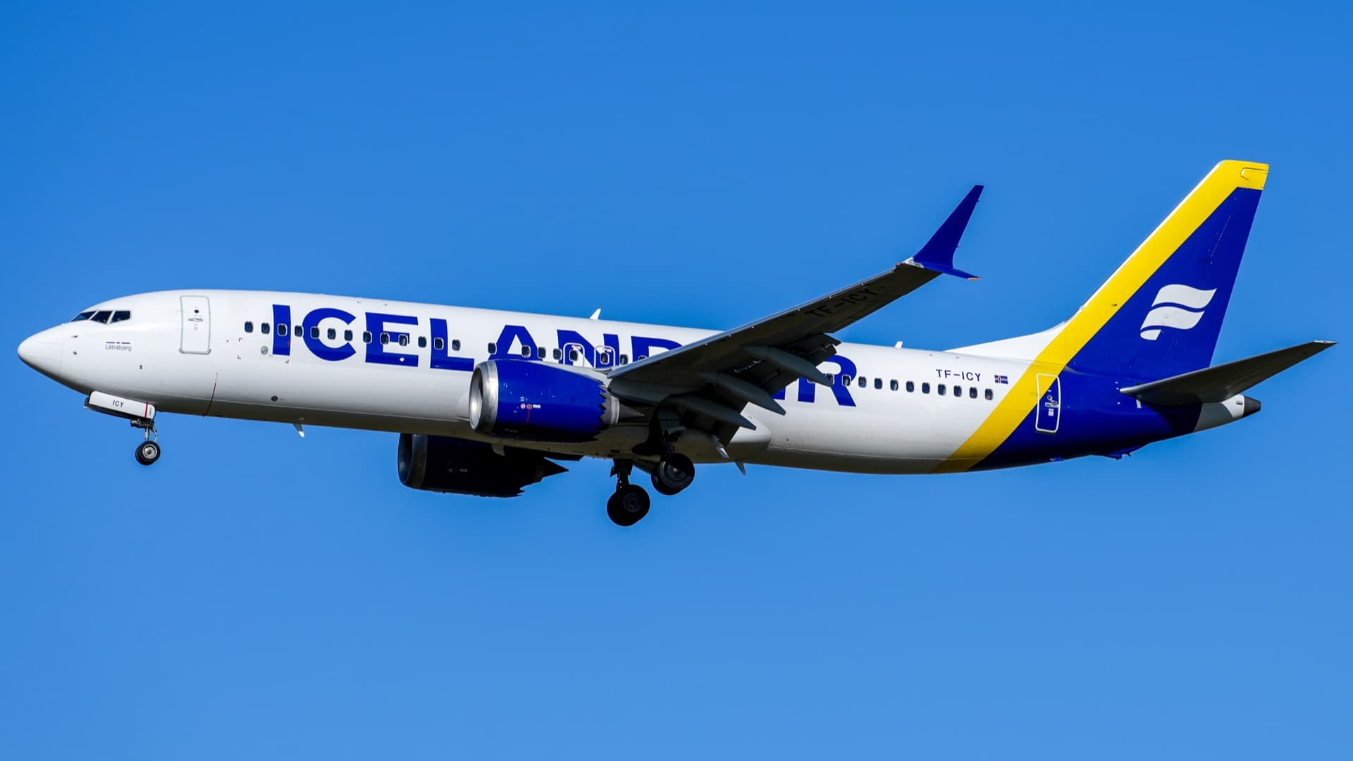 An Icelandair Boeing 737 MAX 8 climbing out after departure, split-tip winglets and the forward-shifted LEAP-1B nacelles visible beneath the wing