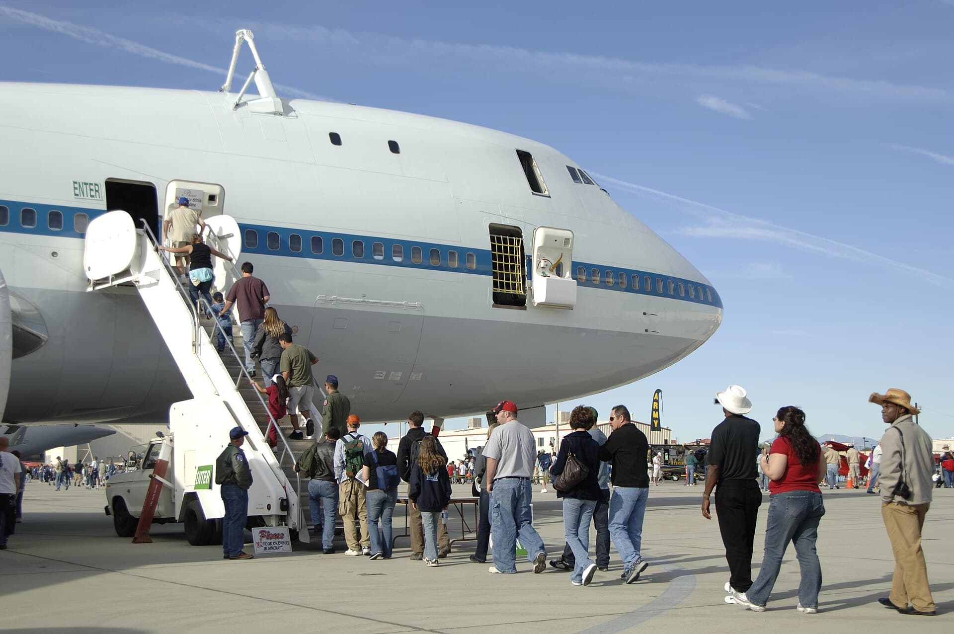 The nose of NASA's modified Boeing 747 Shuttle Carrier Aircraft, visitors filing up a boarding stair during a public open house