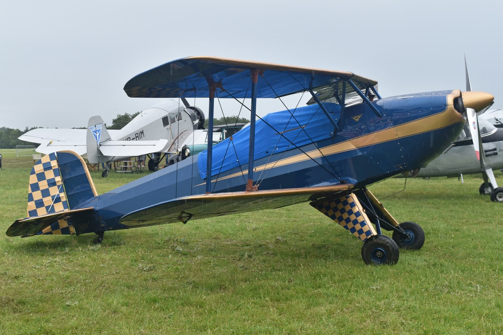 A restored Bücker Bü 131B Jungmann, registration F-AZVK, parked on grass