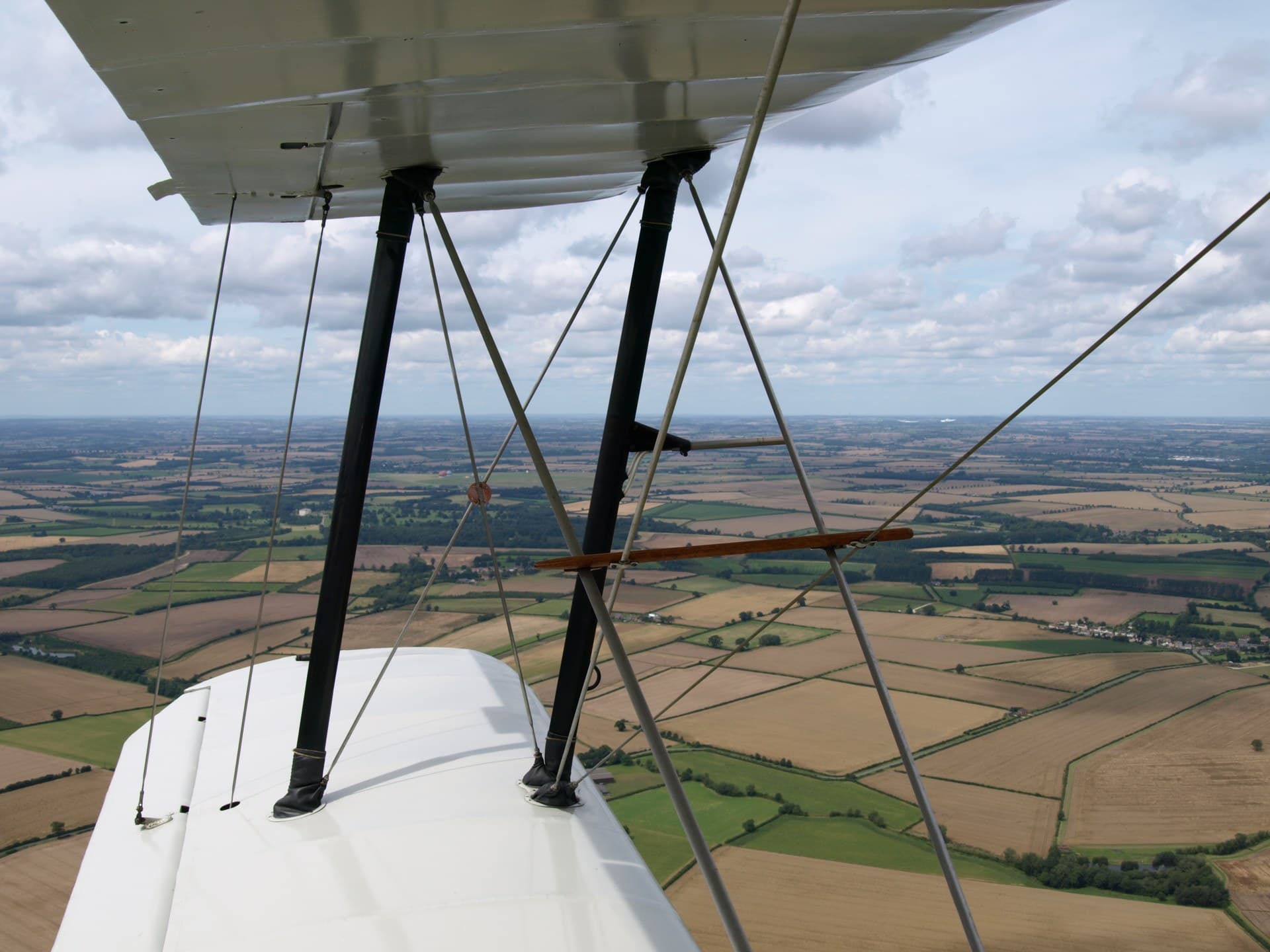 Close detail of a Jungmann's interplane strut and wire bracing, showing the aerobatic biplane's structural bracing