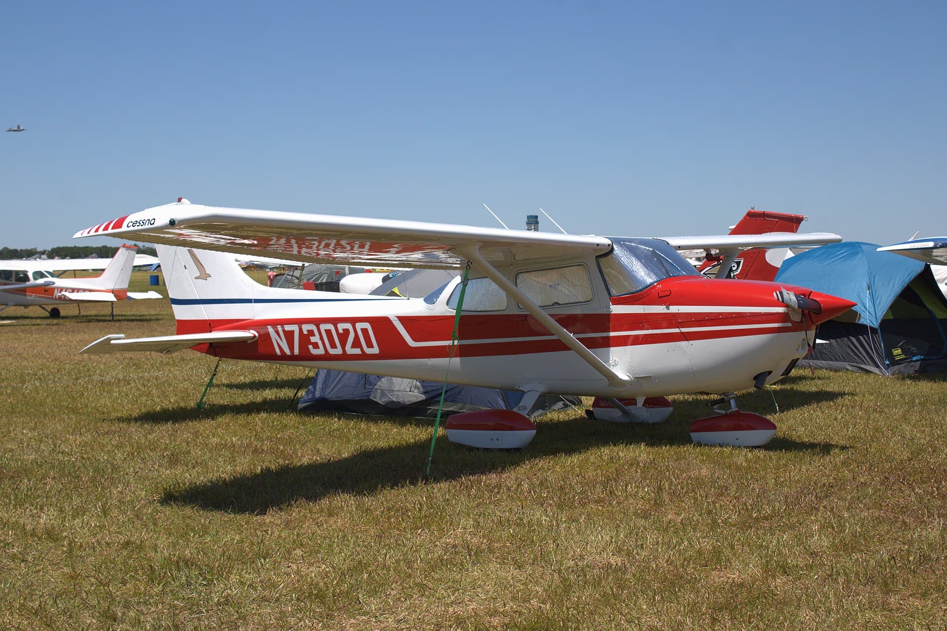 Un Cessna 172M Skyhawk rouge et blanc des années 1970, stationné lors d'un rassemblement aérien