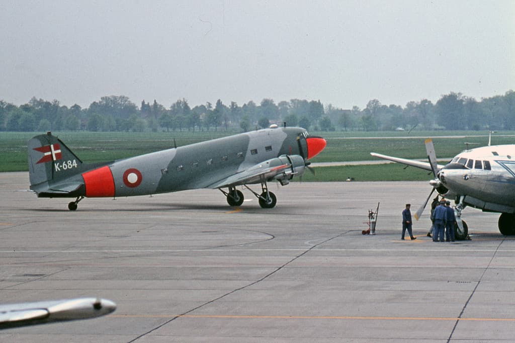 A Douglas C-47A Skytrain, serial K-684, of the Royal Danish Air Force parked on an airfield ramp