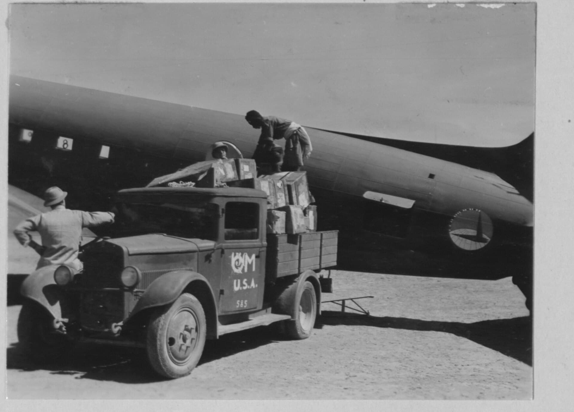 Eritrean labourers unload freight from a Douglas C-47 into a U.S. Army quartermaster truck at the Gura Air Depot, Eritrea, 5 November 1942