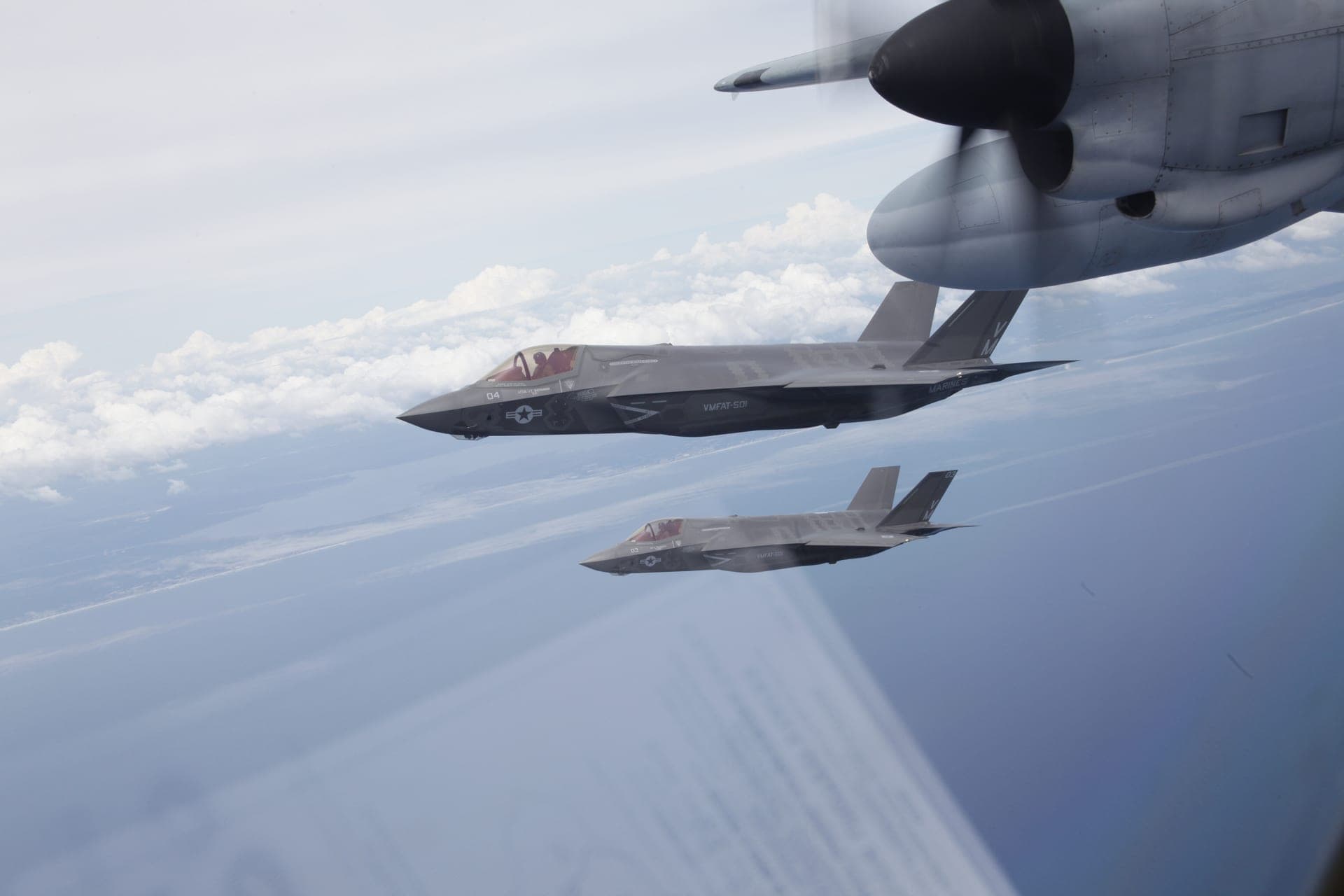 A Marine Corps KC-130 refuels two F-35 fighters in flight