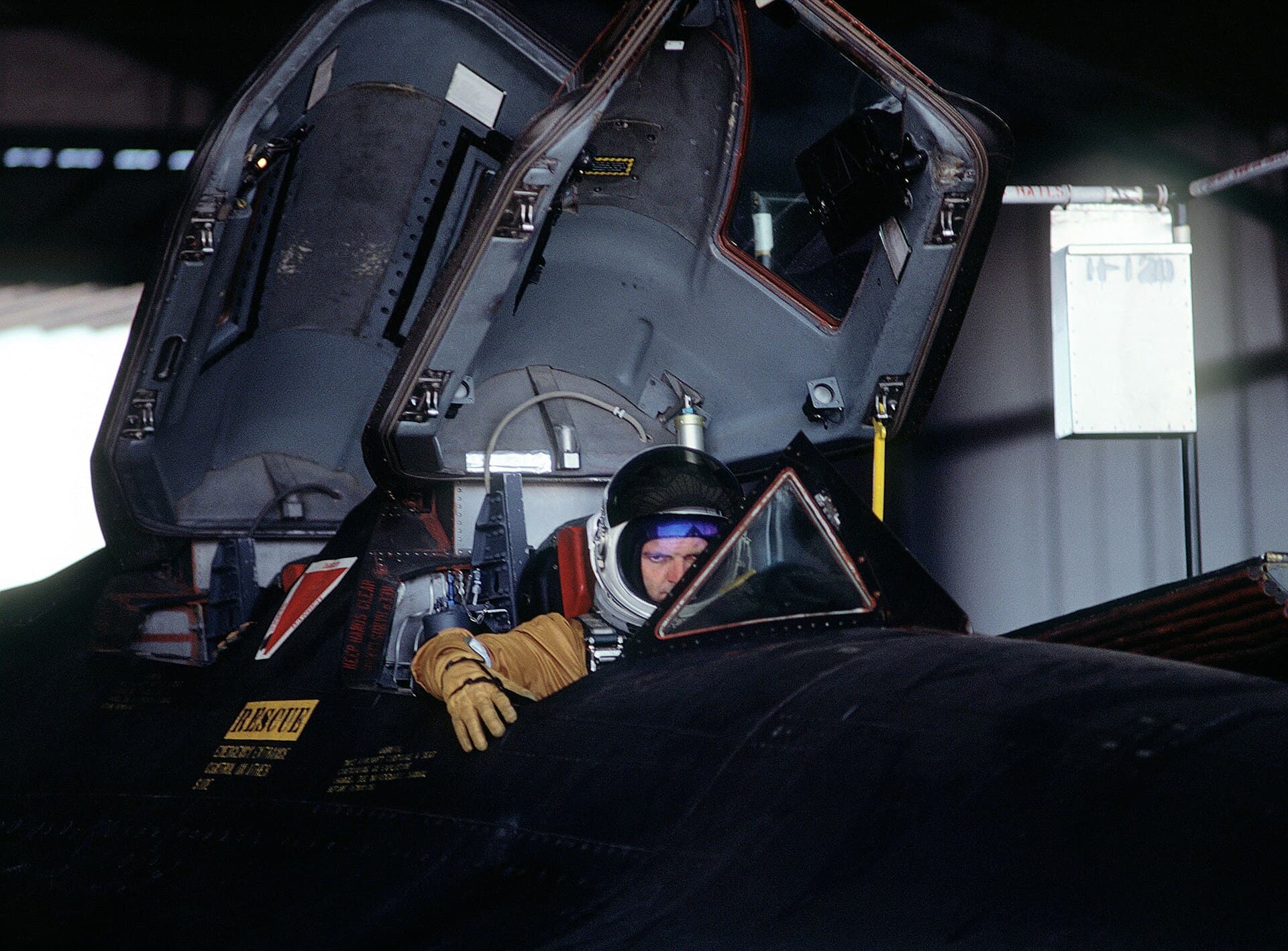 The pilot and reconnaissance systems officer of an SR-71 in their separate, tandem cockpits before a night sortie