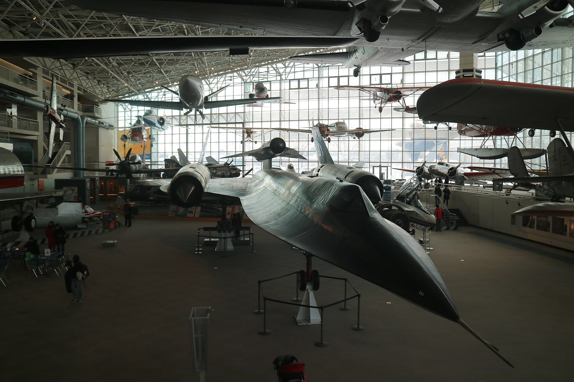 An SR-71 displayed inside the Museum of Flight's main hangar in Seattle, other historic aircraft hanging overhead