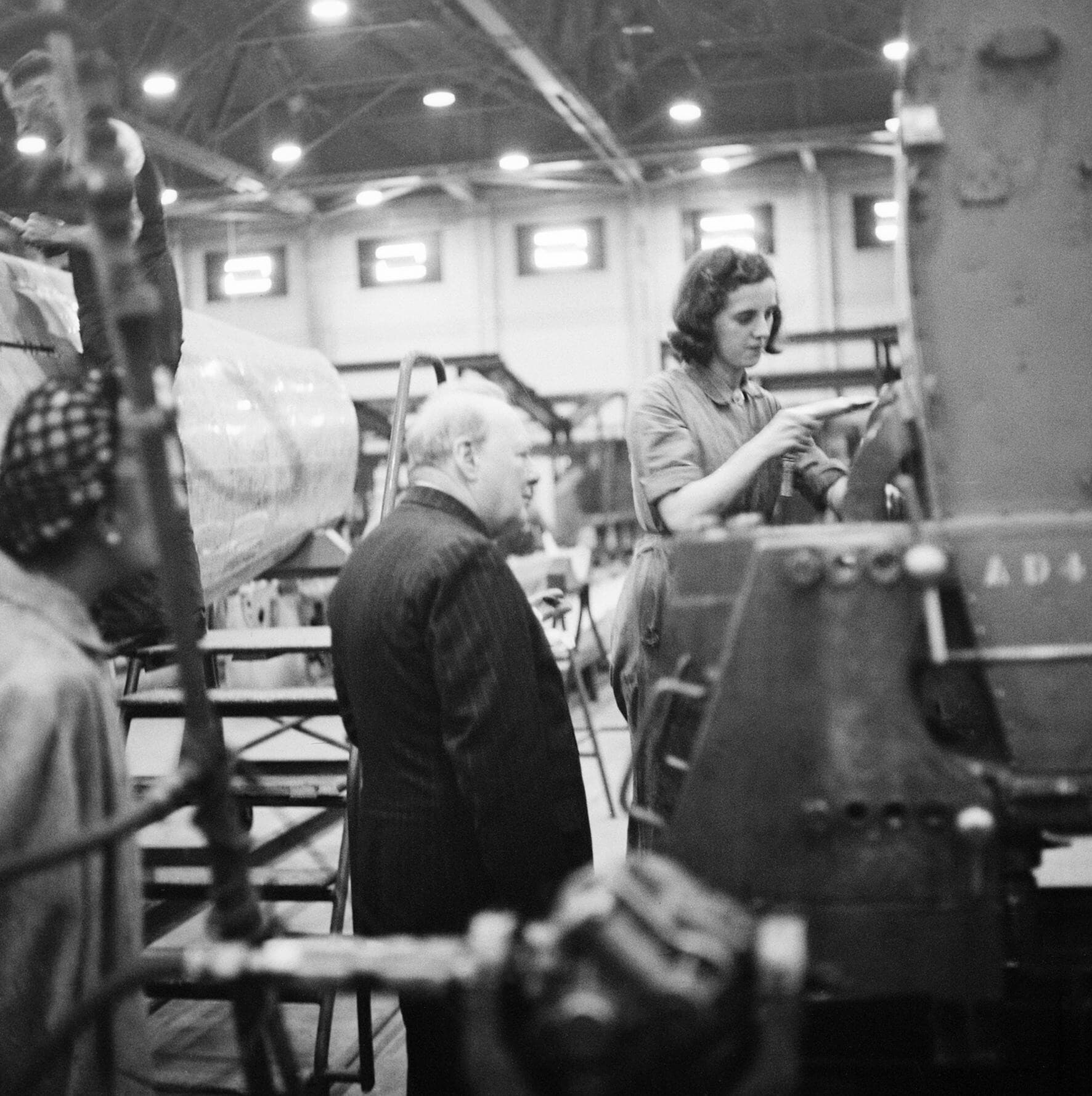 Winston Churchill watches a riveter at work on a Spitfire fuselage at the Castle Bromwich shadow factory, 28 September 1941