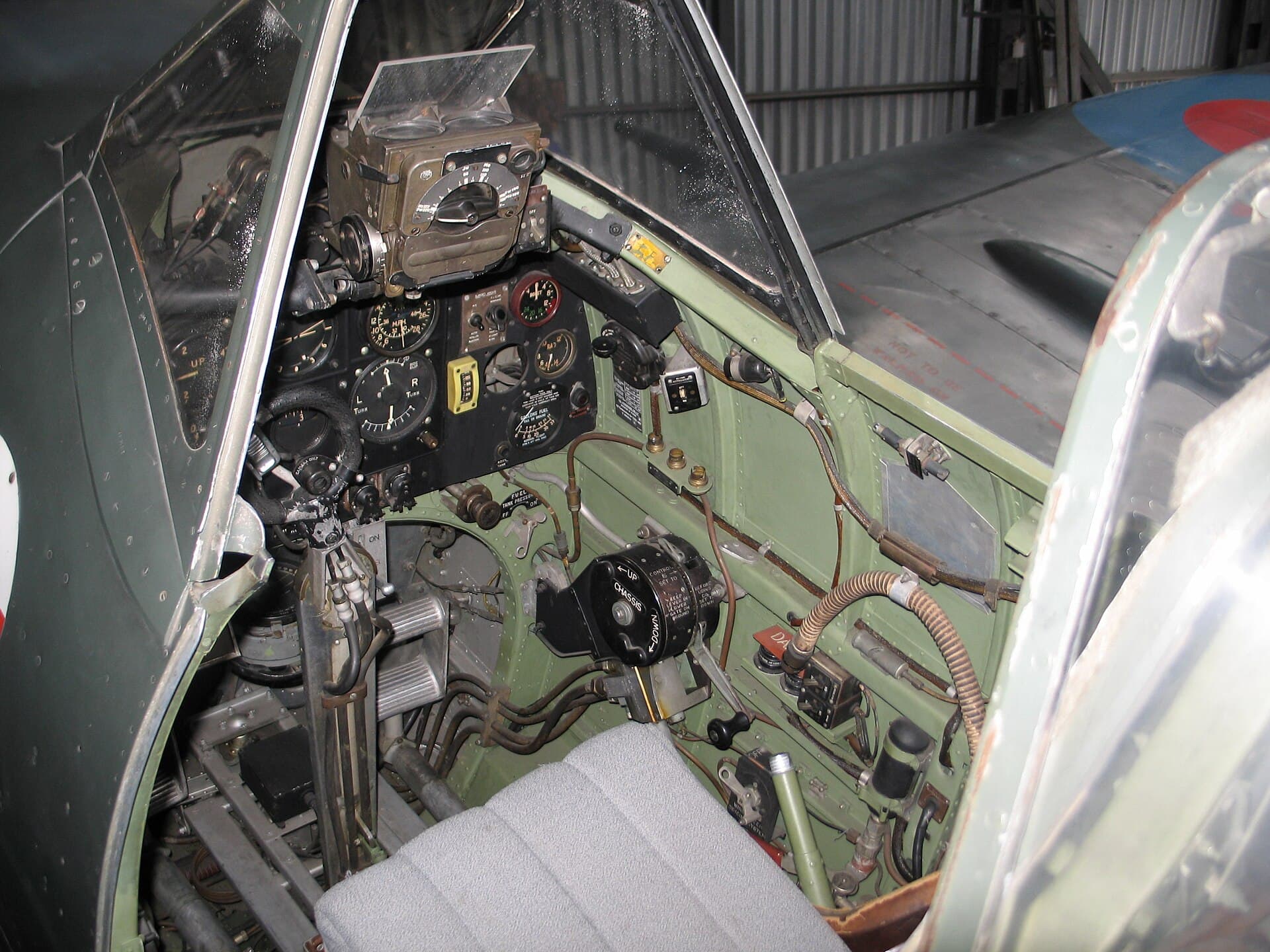 The cramped cockpit of a preserved Spitfire, showing the blind-flying panel and control column
