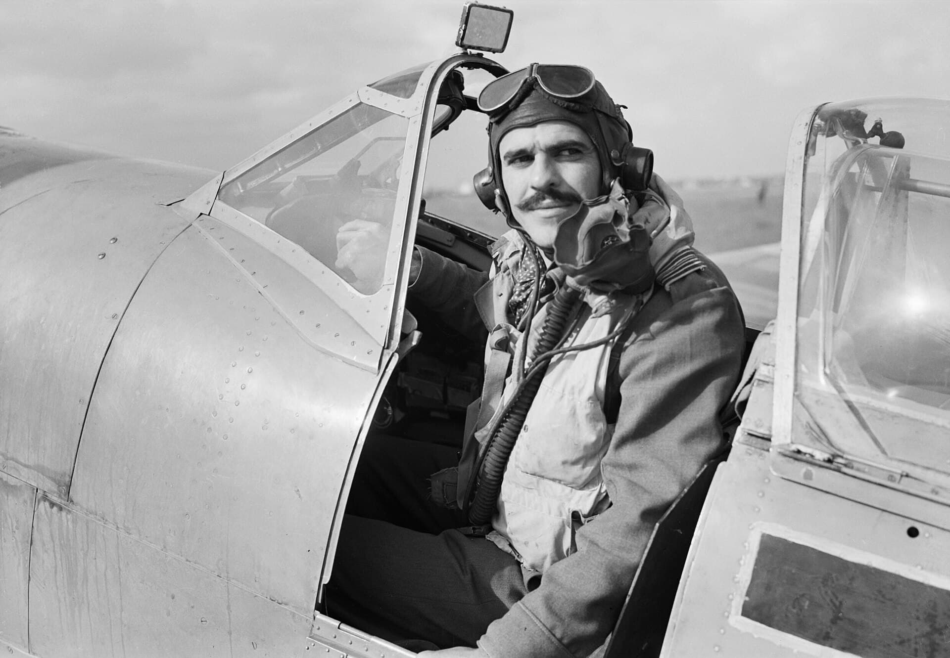 Squadron Leader L. C. Wade in the cockpit of his Spitfire HF Mk VIII at Triolo landing ground, Italy, 12 November 1943