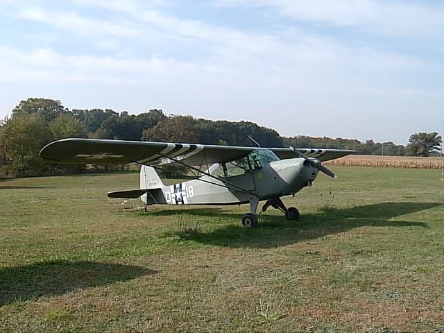 A restored olive-drab Taylorcraft L-2 Grasshopper liaison aircraft
