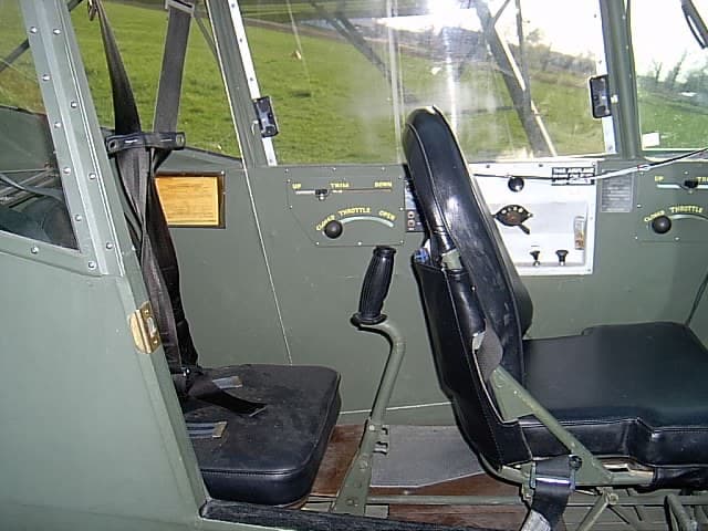 The cockpit of a Taylorcraft L-2 Grasshopper, with basic flight instruments and observer glazing