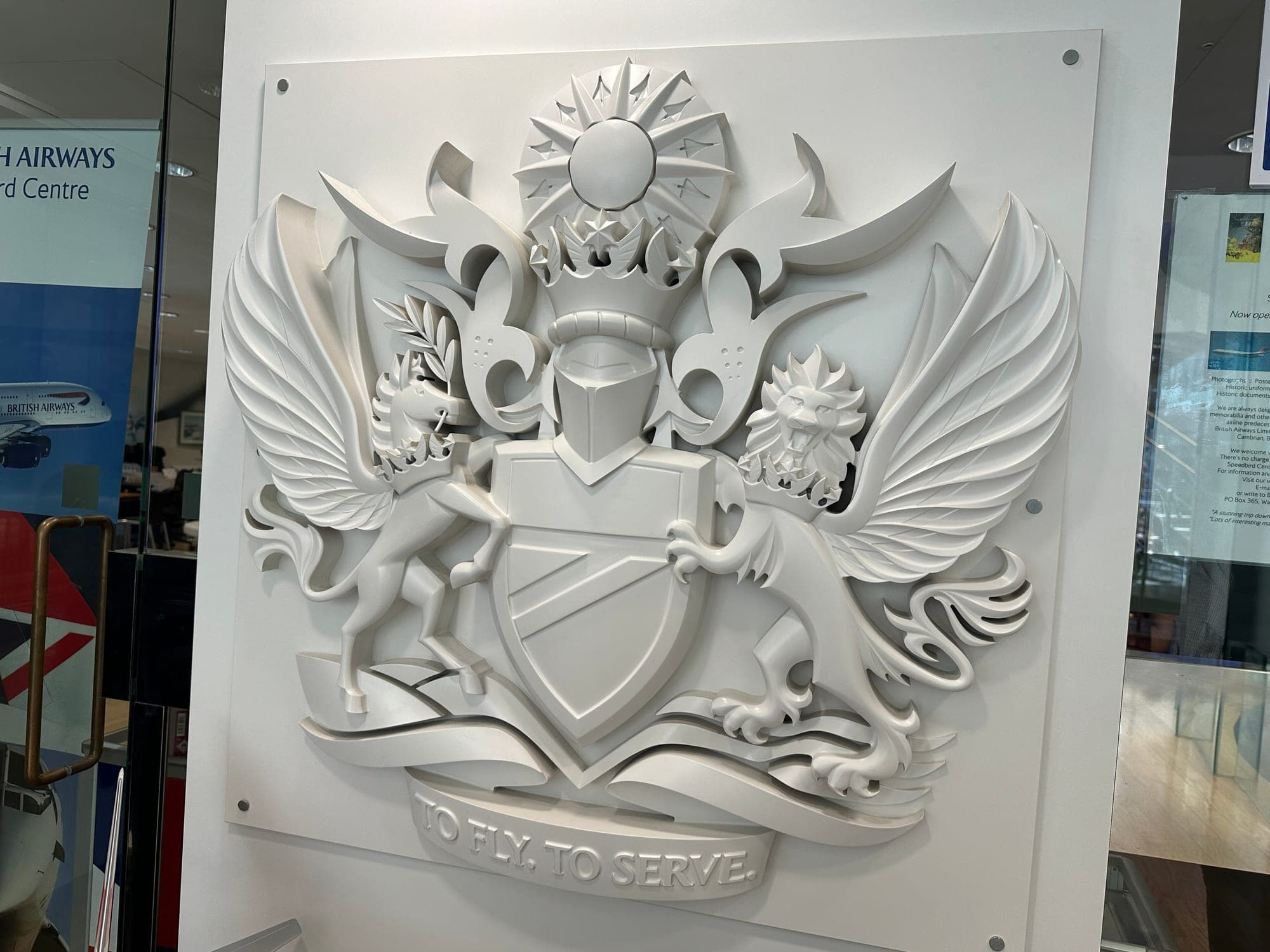 The British Airways coat of arms, with the motto To Fly To Serve, displayed at Waterside in 2024.