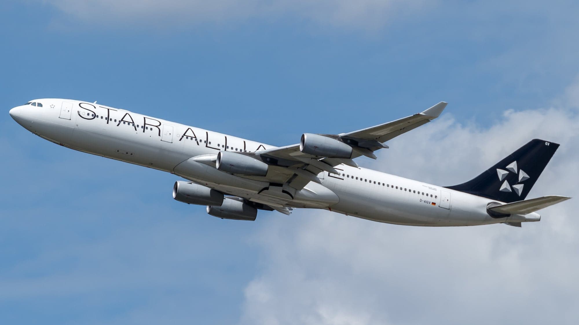 A Lufthansa Airbus A340-300, registration D-AIGV, in Star Alliance livery climbing out of Frankfurt in June 2017.