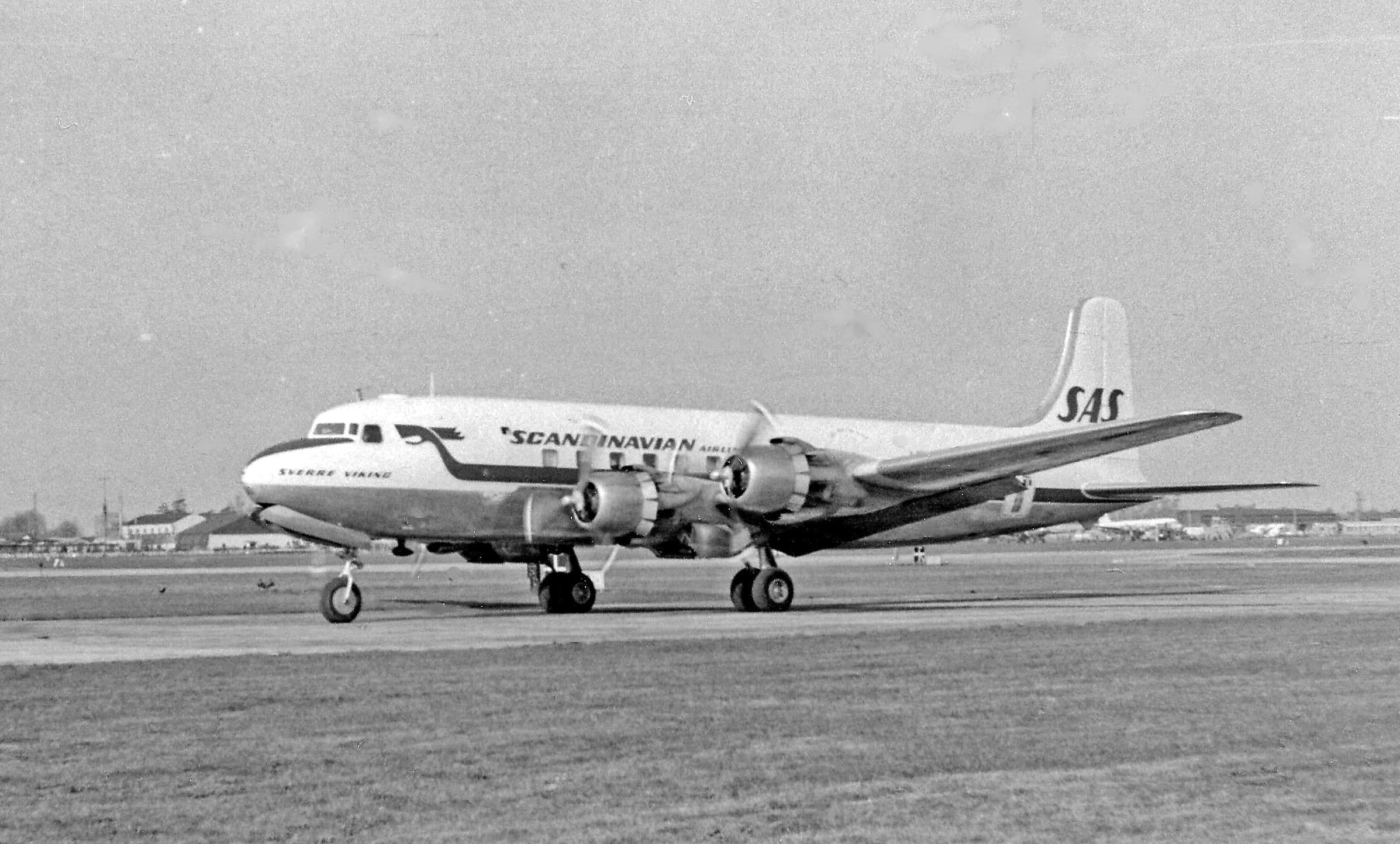 A Scandinavian Airlines airliner taking off from Heathrow in April 1955, watched from the Queen's Building
