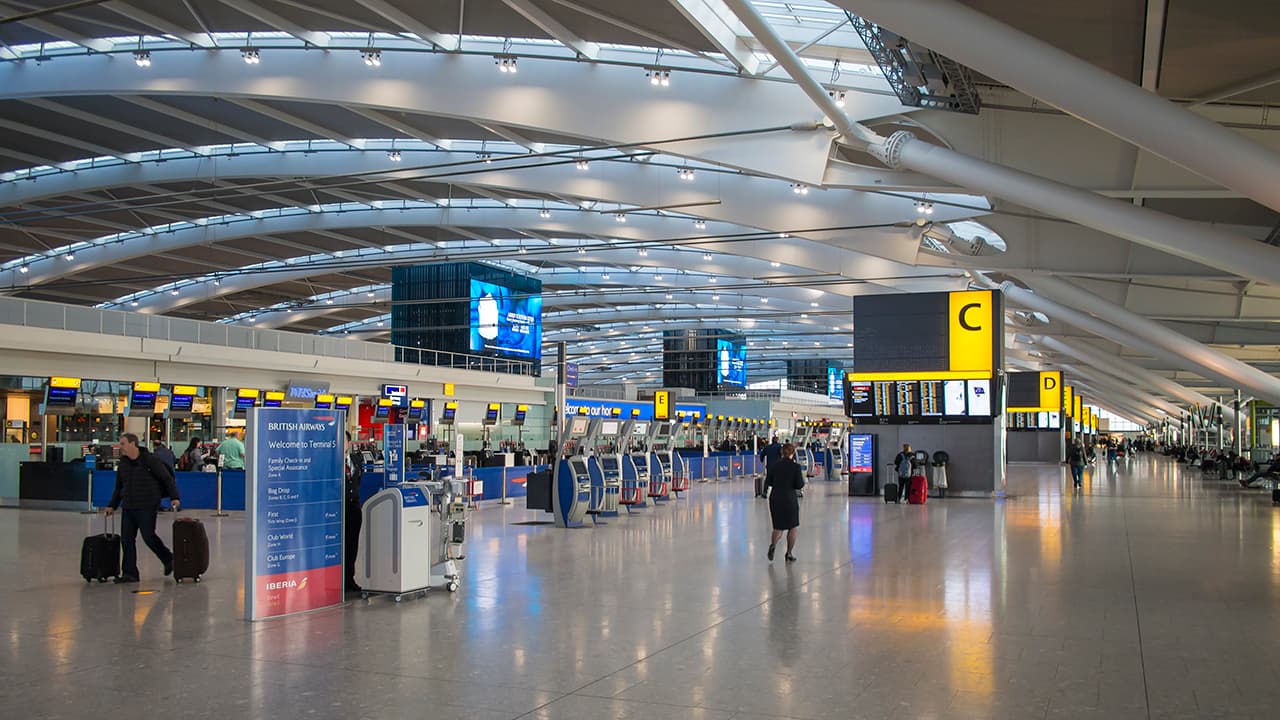 The check-in concourse of Terminal 5 under its single-span waveform roof