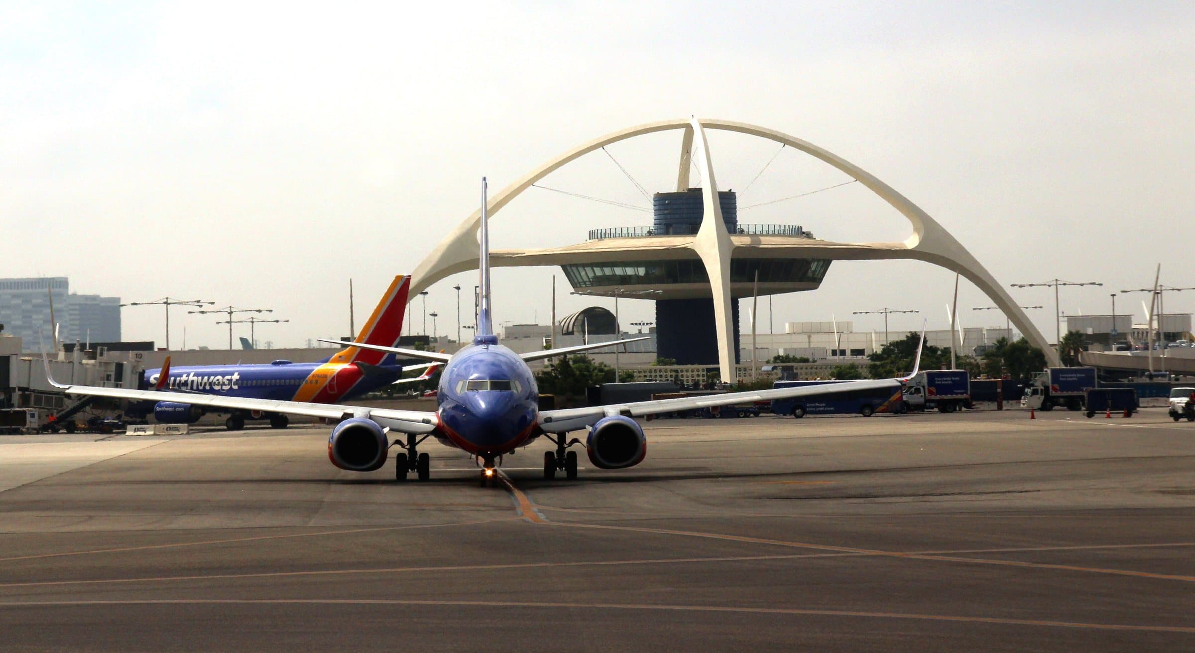 A Southwest Airlines Boeing 737 taxiing past the Theme Building in 2017