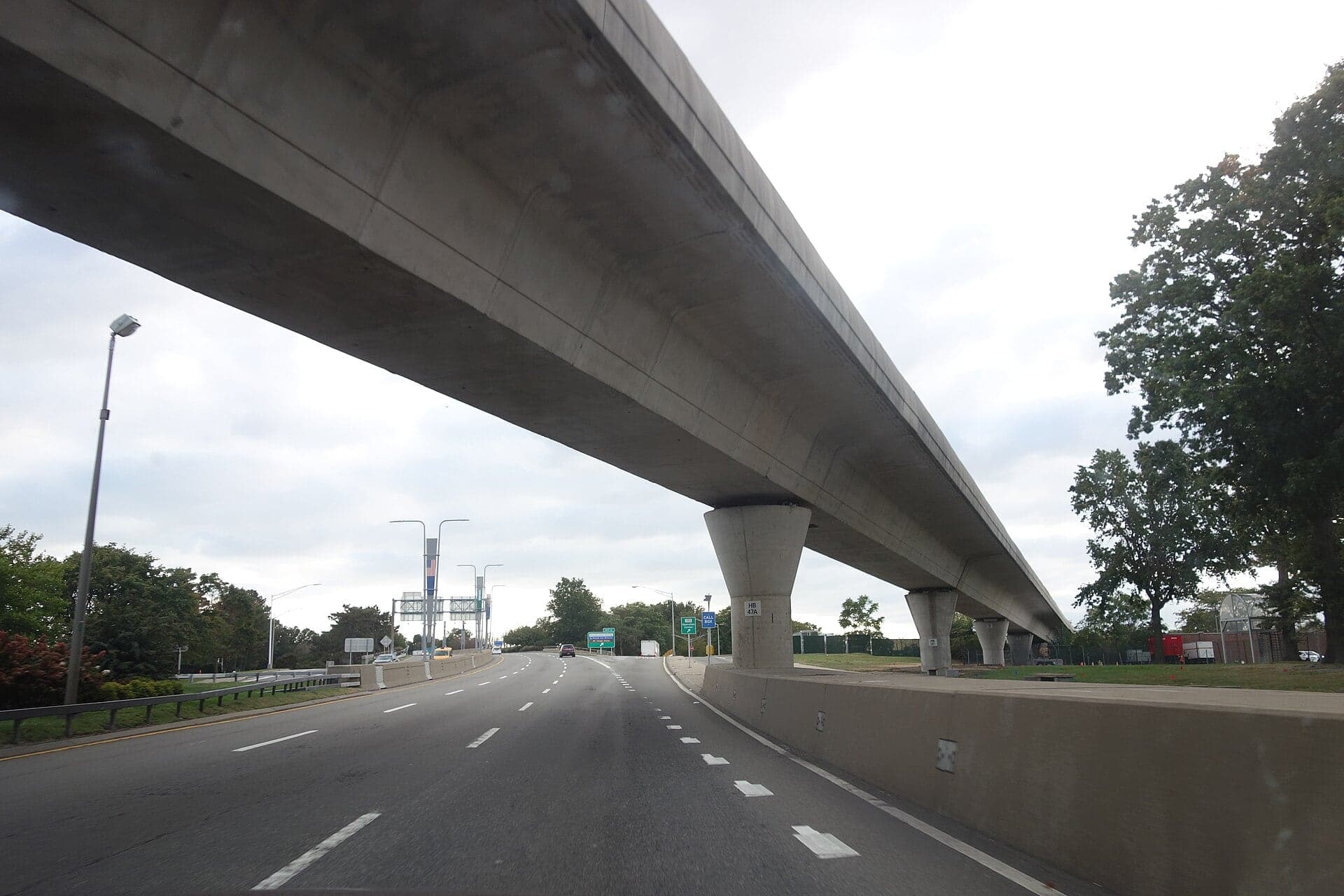 The concrete AirTrain JFK viaduct running above the Van Wyck Expressway towards Jamaica in 2021