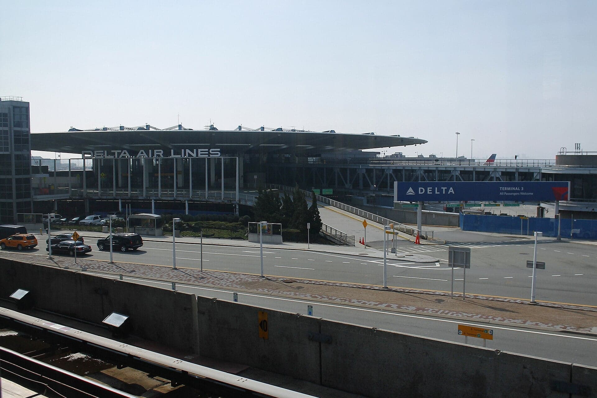 The former Pan Am Worldport as Delta's Terminal 3 in April 2013, weeks before demolition began, its flat saucer roof seen across the AirTrain line