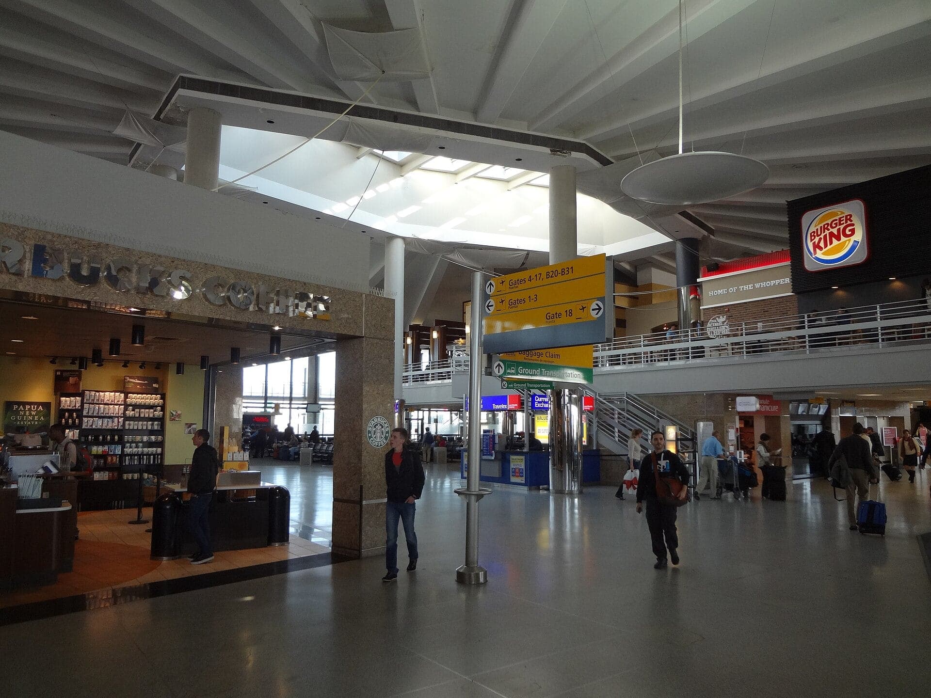 Inside Terminal 3 in 2012, the former Worldport's departure hall with its low ceiling, skylights and airport shops