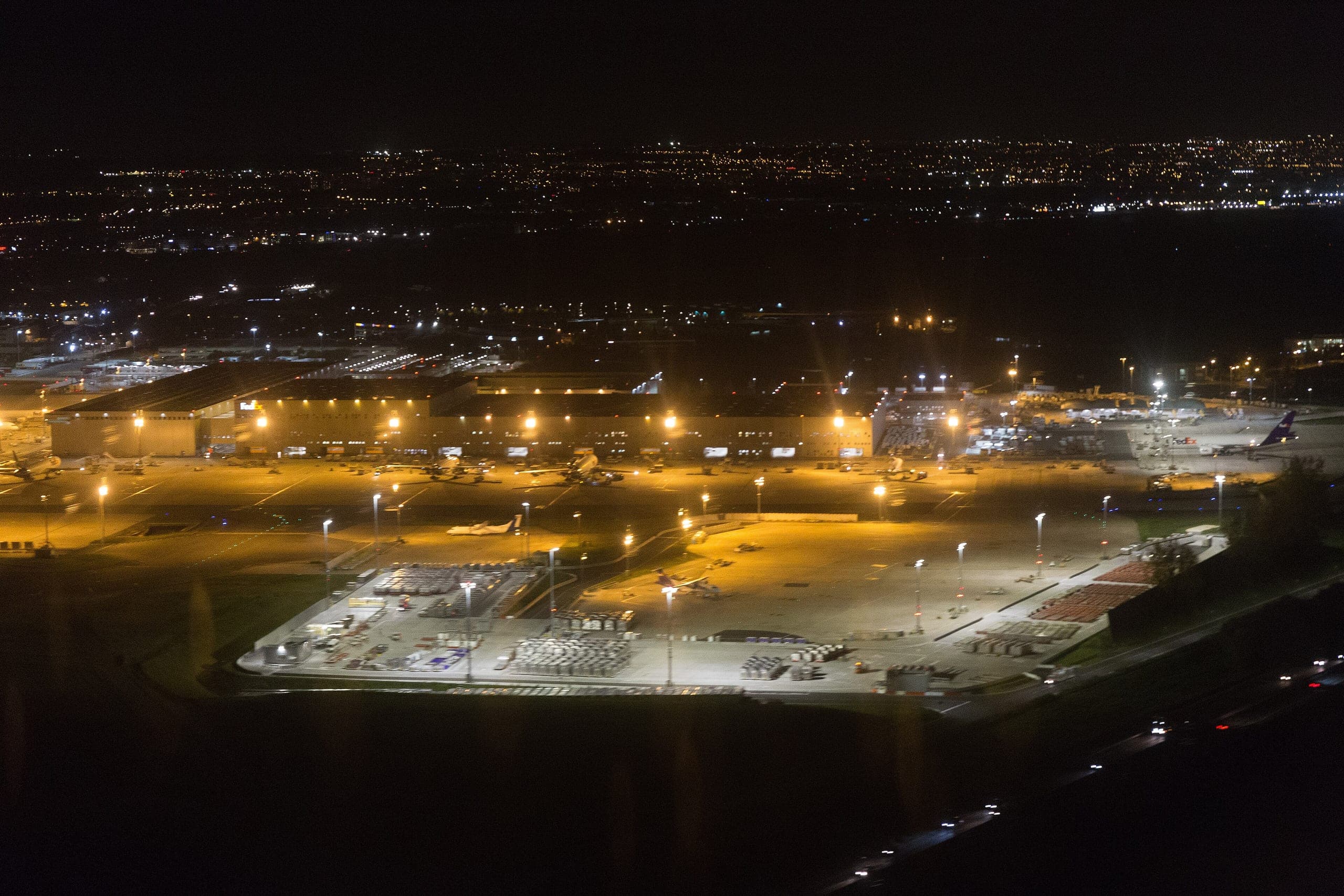 The FedEx Express European hub at Charles de Gaulle from the air at night, freighters on stand around the sort building