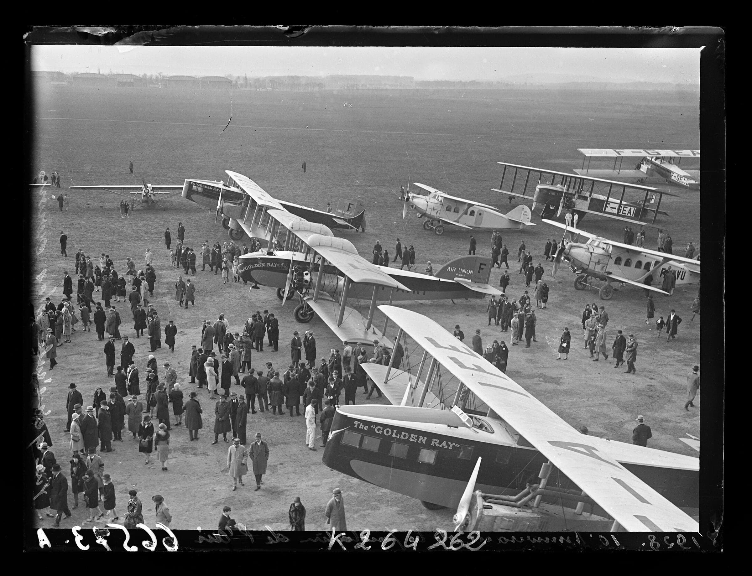 Biplane airliners lined up on the grass at Le Bourget among spectators for the tenth anniversary of the Paris to London air service in 1929