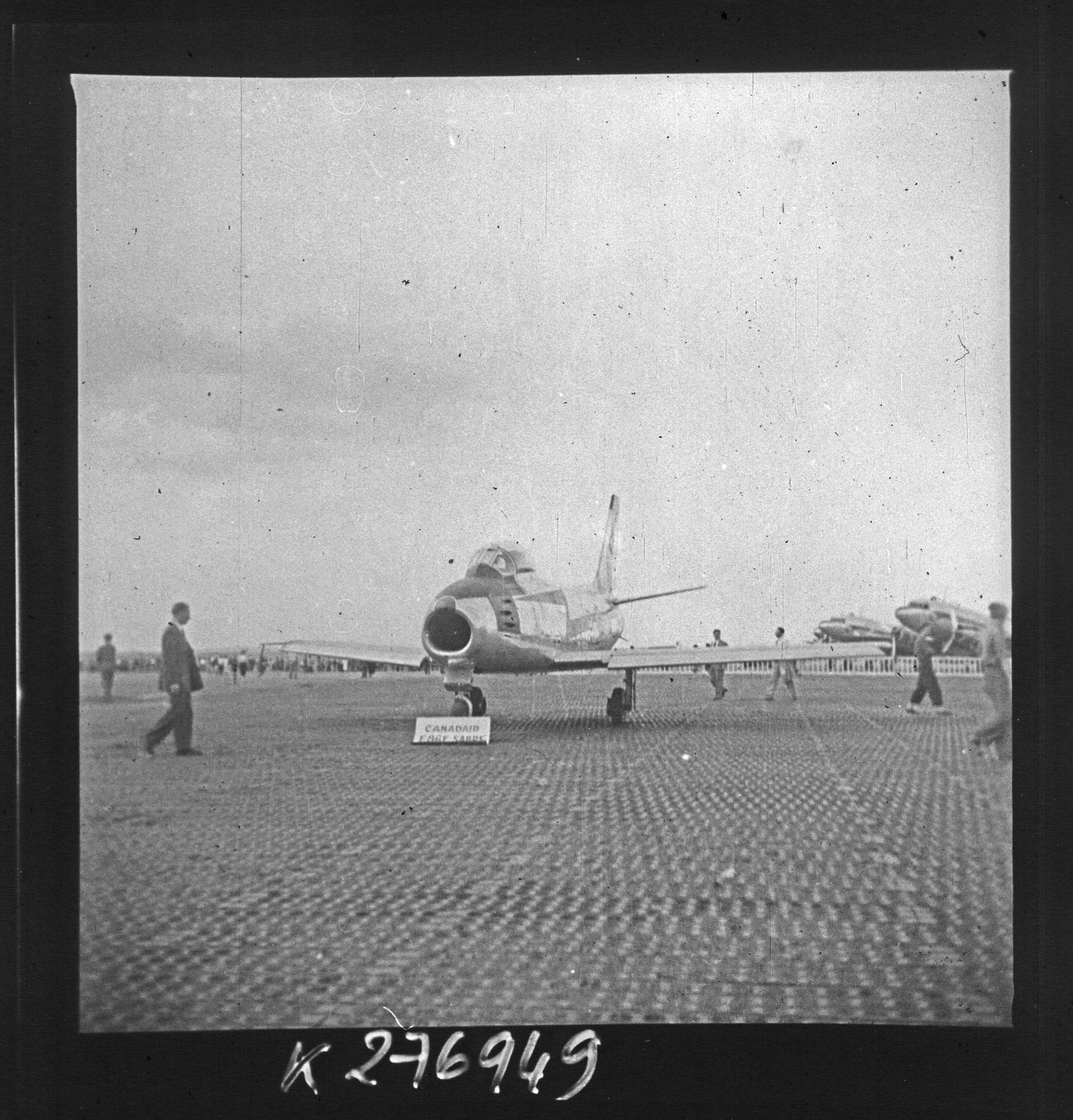 A swept-wing jet fighter displayed on the concrete at the twentieth Salon international de l'aéronautique, the first held at Le Bourget, in 1953