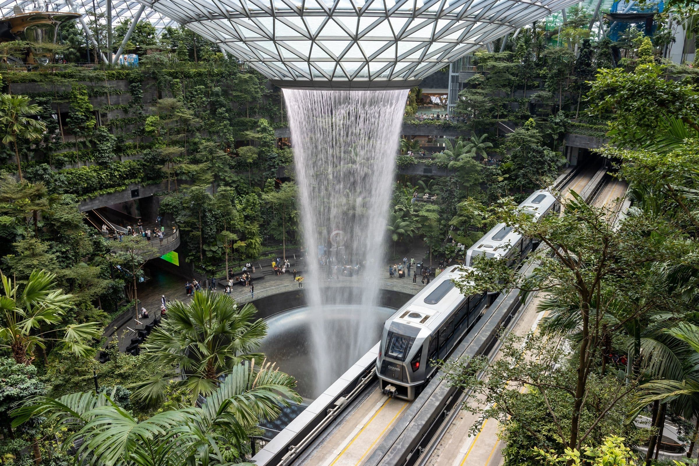 The Skytrain passing the Rain Vortex inside Jewel in 2023
