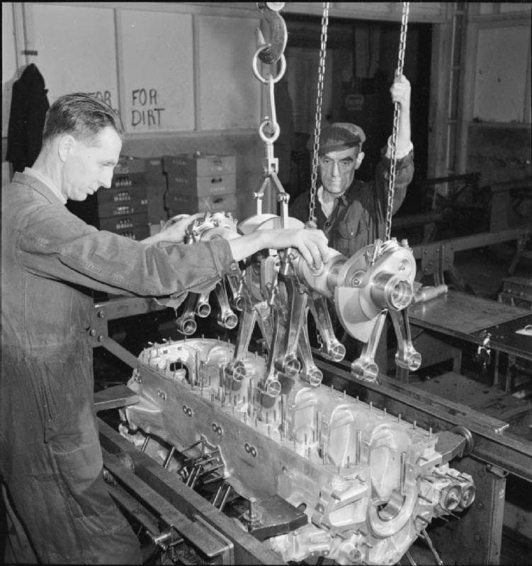 Two workers lowering a Merlin crankshaft assembly into its crankcase, 1942