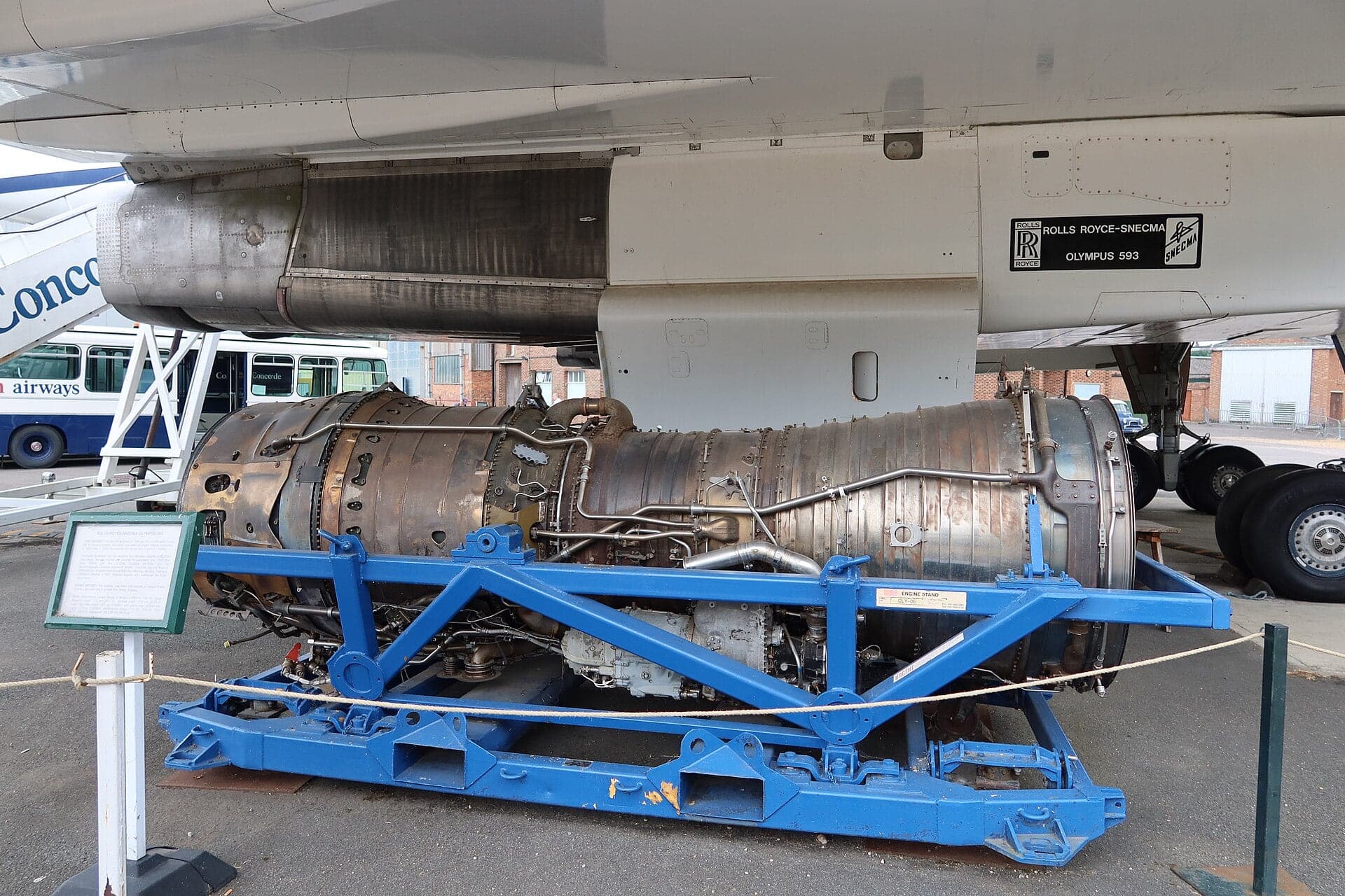 An Olympus 593 on a blue stand beneath Concorde G-BBDG at Brooklands Museum, Surrey, in July 2022