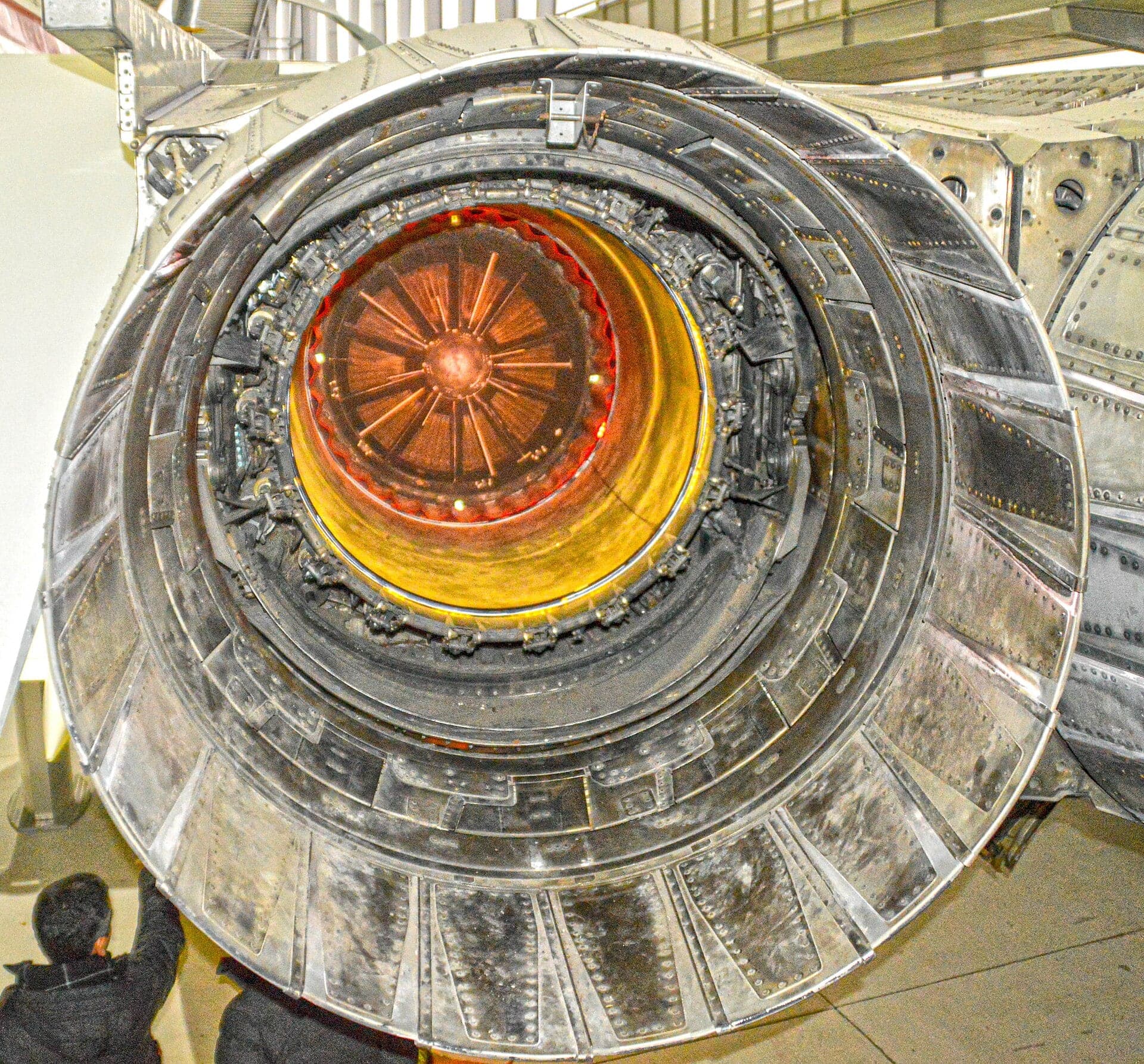 Looking into the rear of a Concorde nacelle at IWM Duxford, the jet pipe glowing under display lighting inside the nozzle