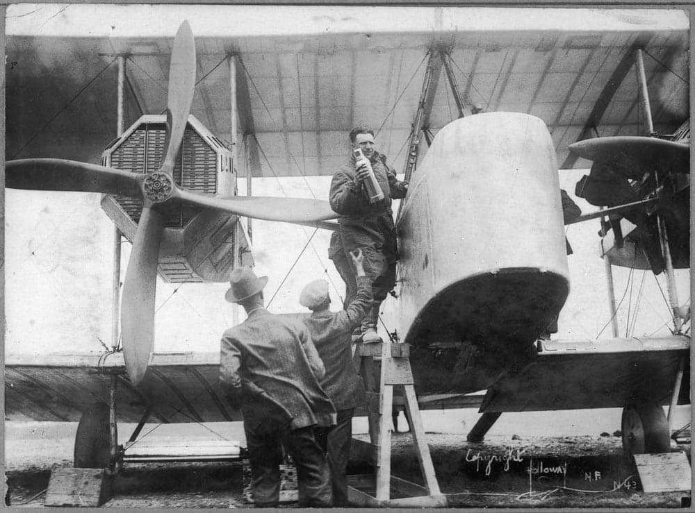John Alcock stowing provisions in the Vimy's cockpit before the flight