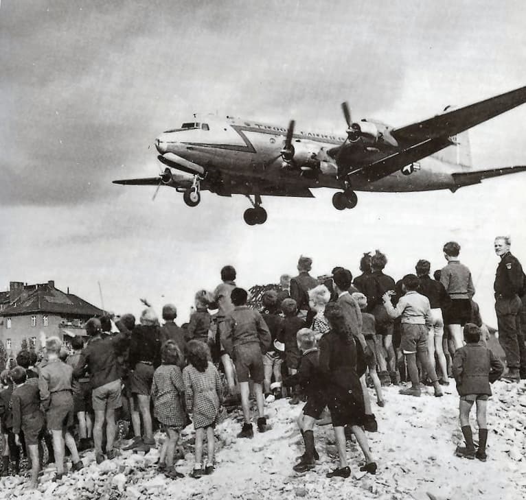 A C-54 landing at Tempelhof in 1948, watched from the rubble