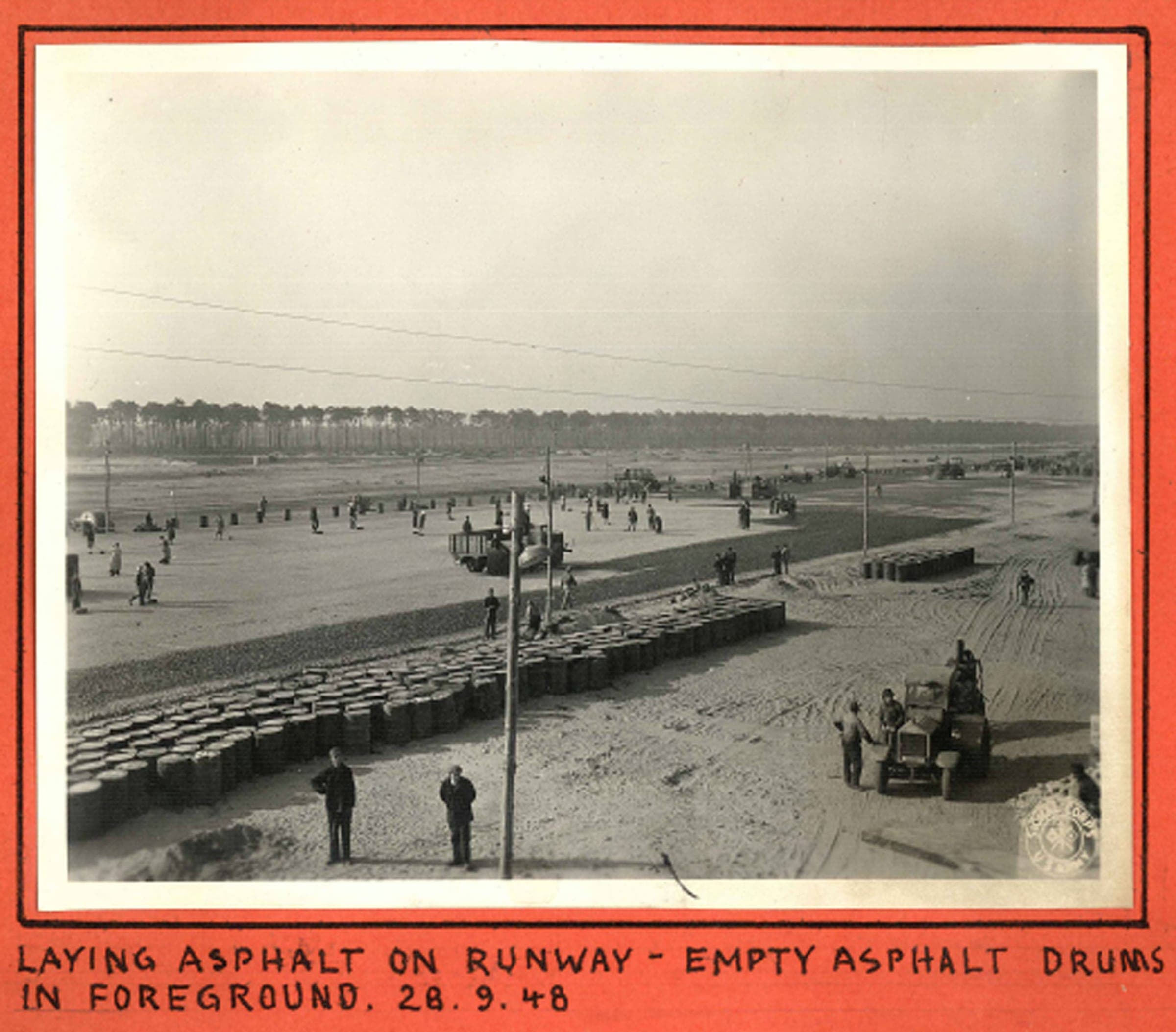 Asphalt going down on the Tegel runway, empty drums in the foreground, 28 September 1948