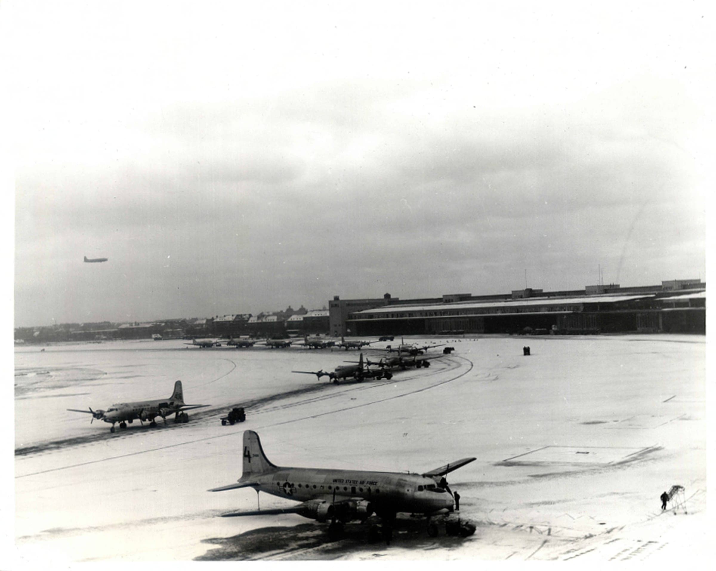 C-54s unloading on the snow-covered semi-circular ramp at Tempelhof