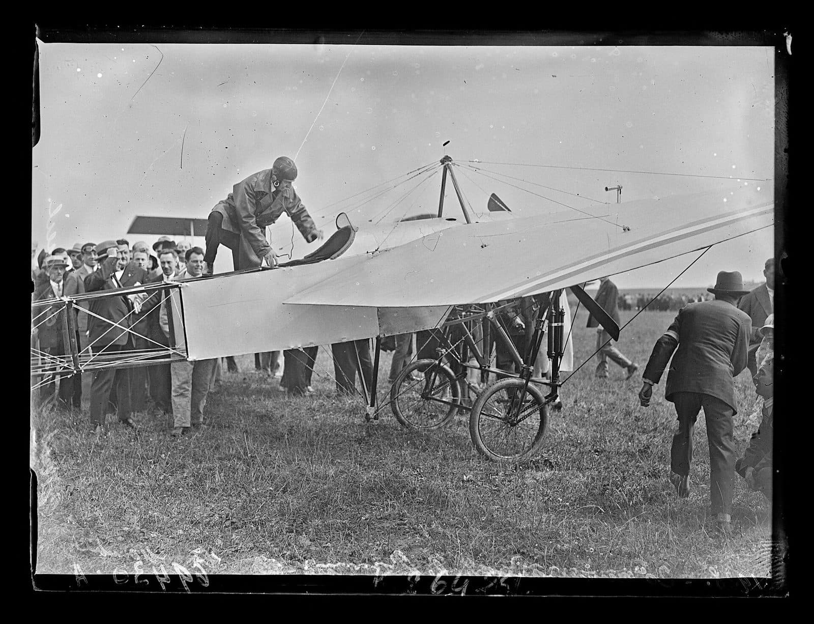 Louis Blériot seated in the cockpit of a monoplane at Calais for the twentieth anniversary of the crossing.