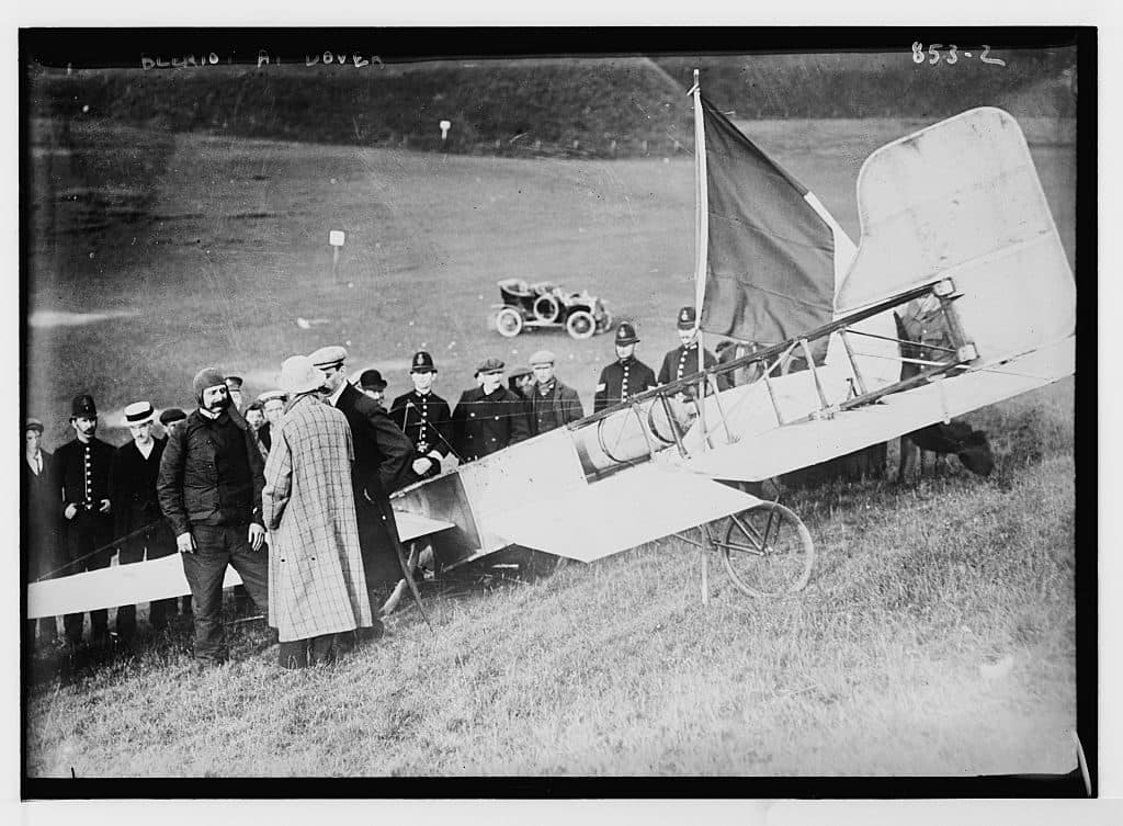The monoplane tipped on the slope of Northfall Meadow with a French tricolour planted beside it, police and visitors around.