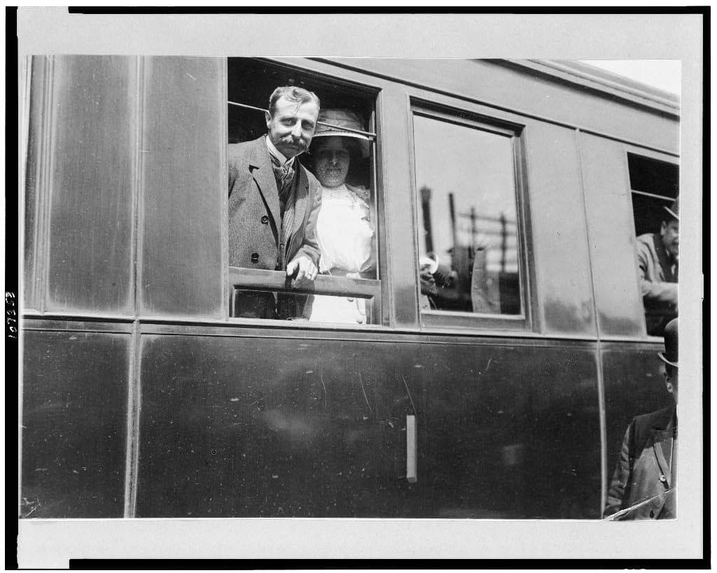 Louis and Alice Blériot at the window of a railway carriage on the train from Calais to Paris.
