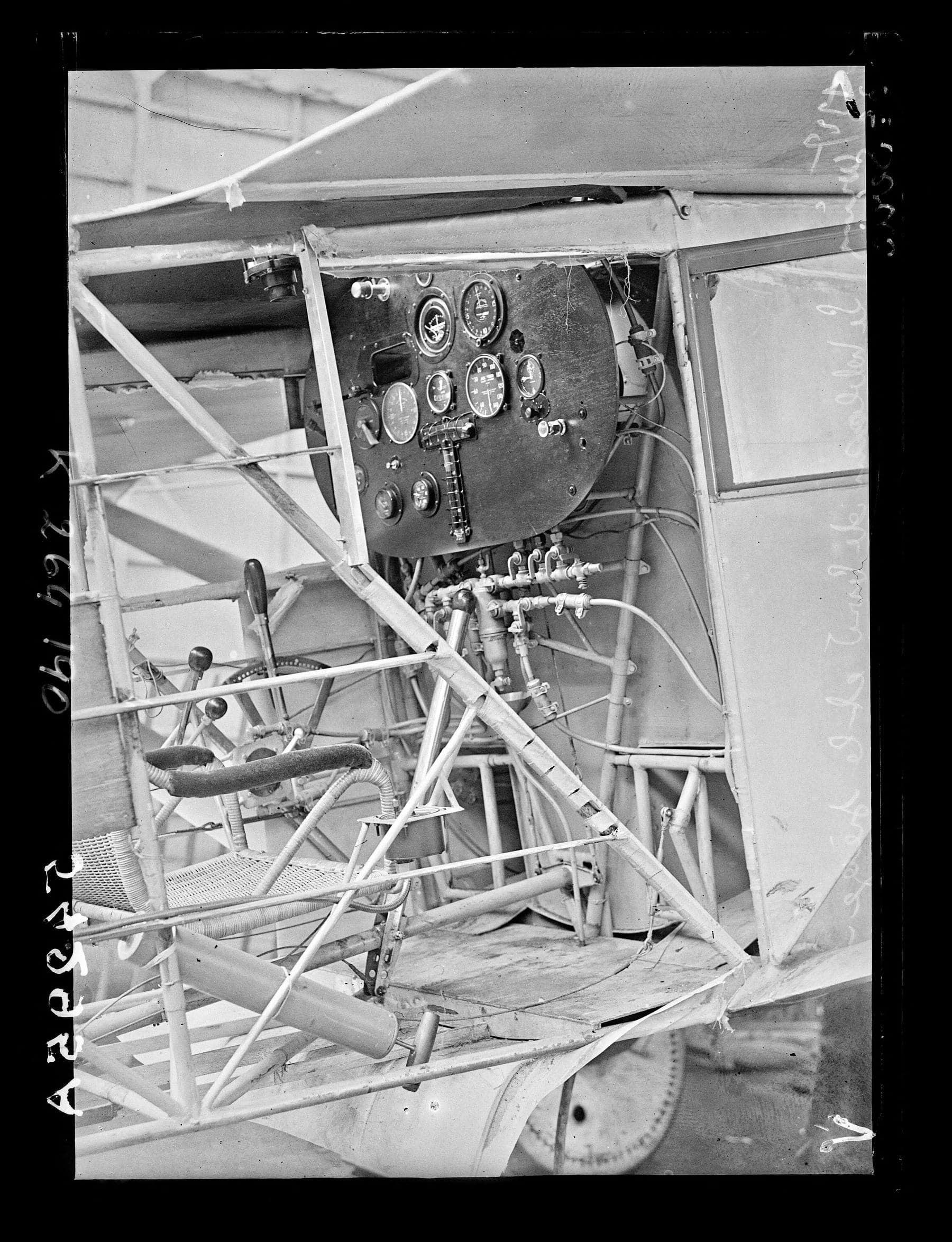 The cramped cockpit seen from the door: the instrument panel and the wicker seat Lindbergh sat in for thirty-three hours.