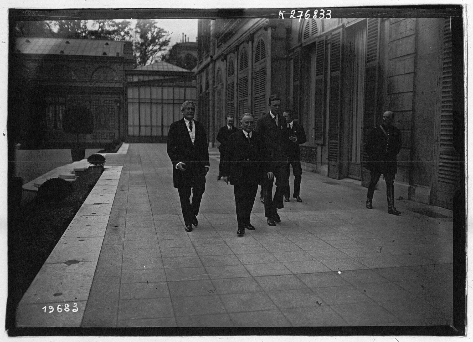 Lindbergh, tall and bareheaded, walking with French officials in Paris in the days after the flight.