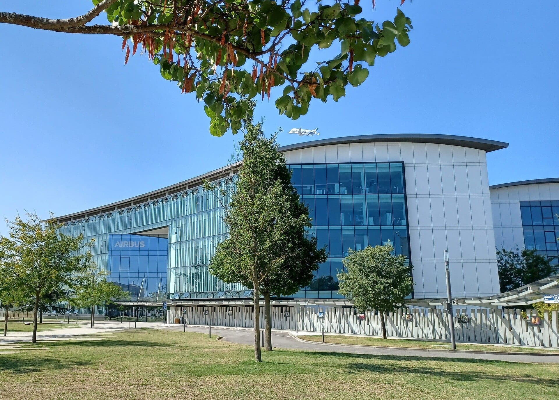 Airbus headquarters at Toulouse-Blagnac, with a BelugaXL passing overhead