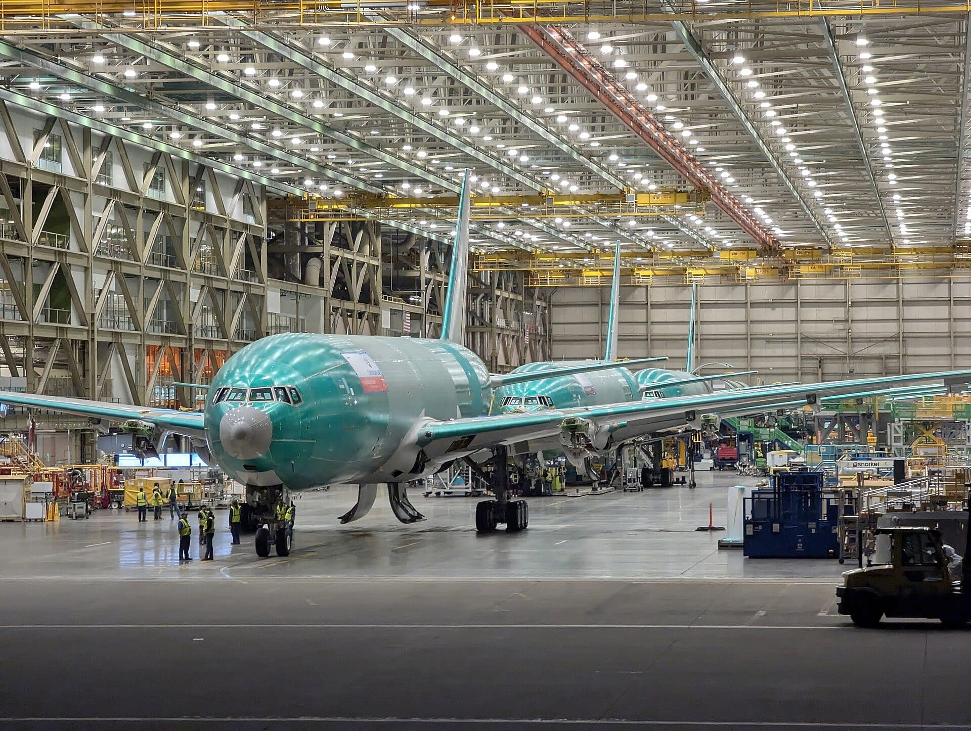 Unpainted Boeing 777X fuselages standing in line inside the Everett assembly hall
