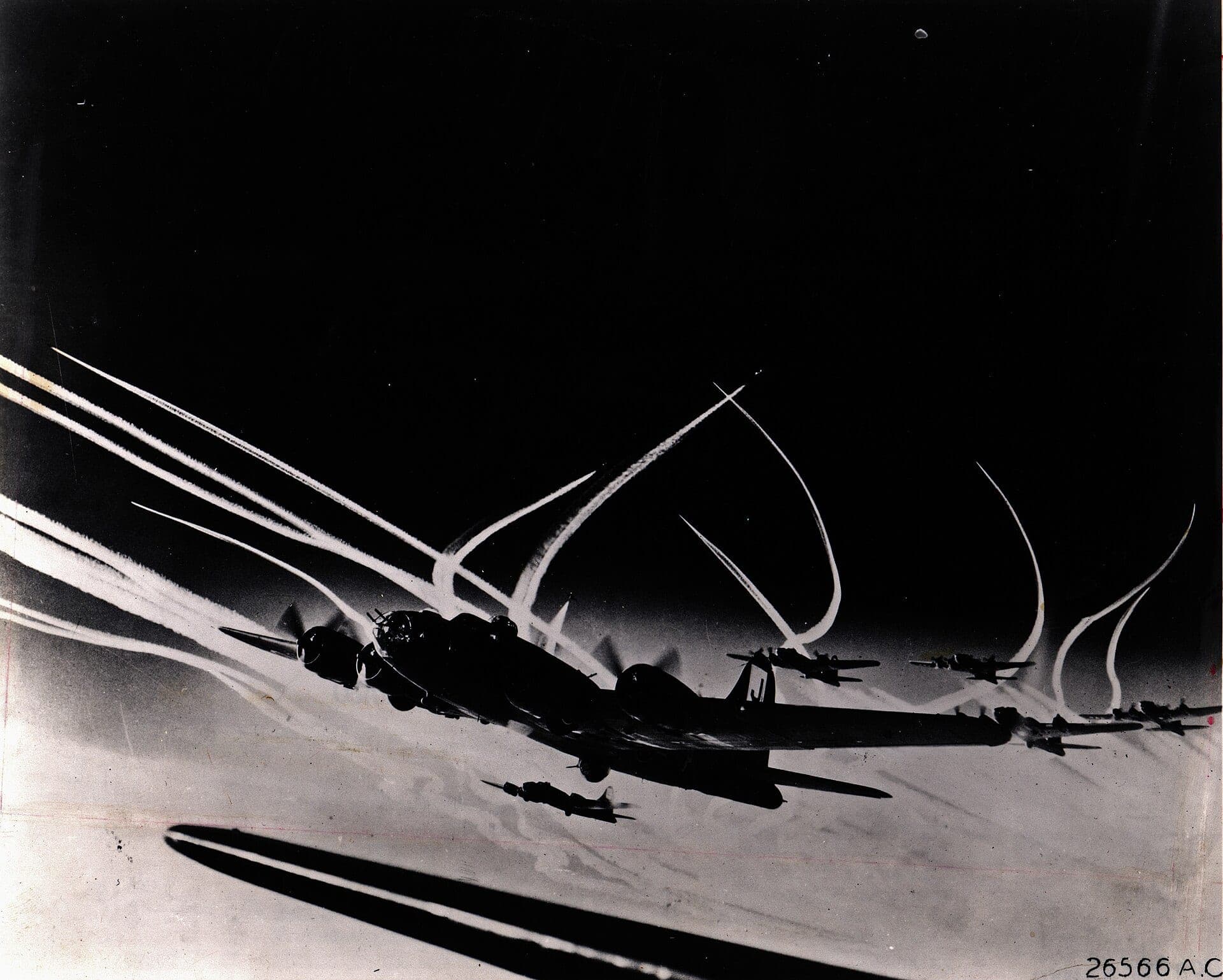 A formation of Eighth Air Force B-17F Flying Fortresses over Europe in 1943, trailing contrails