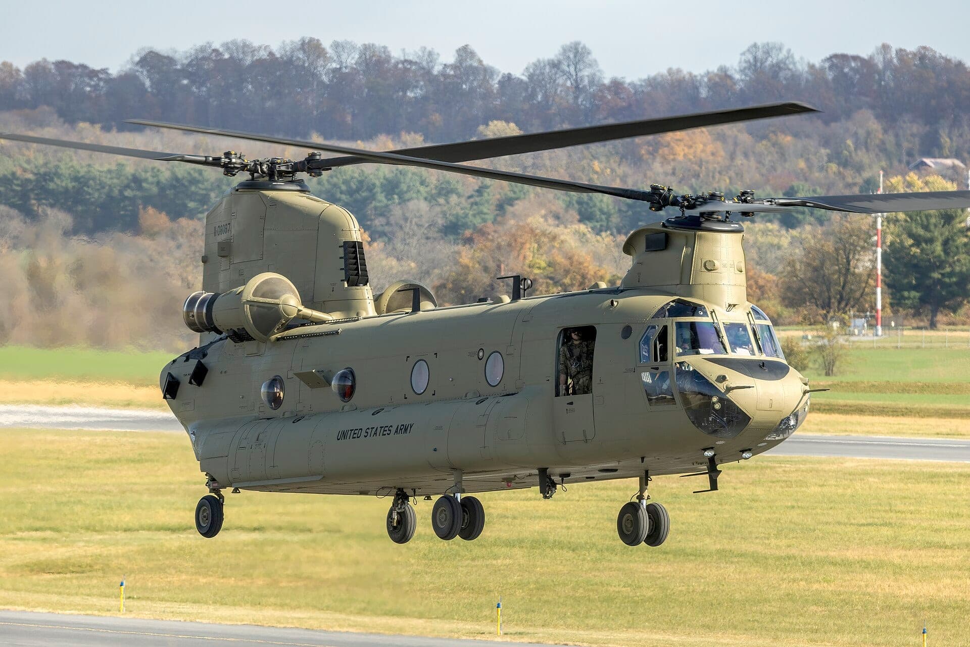 A U.S. Army Boeing CH-47F Chinook hovering, its tandem rotors turning