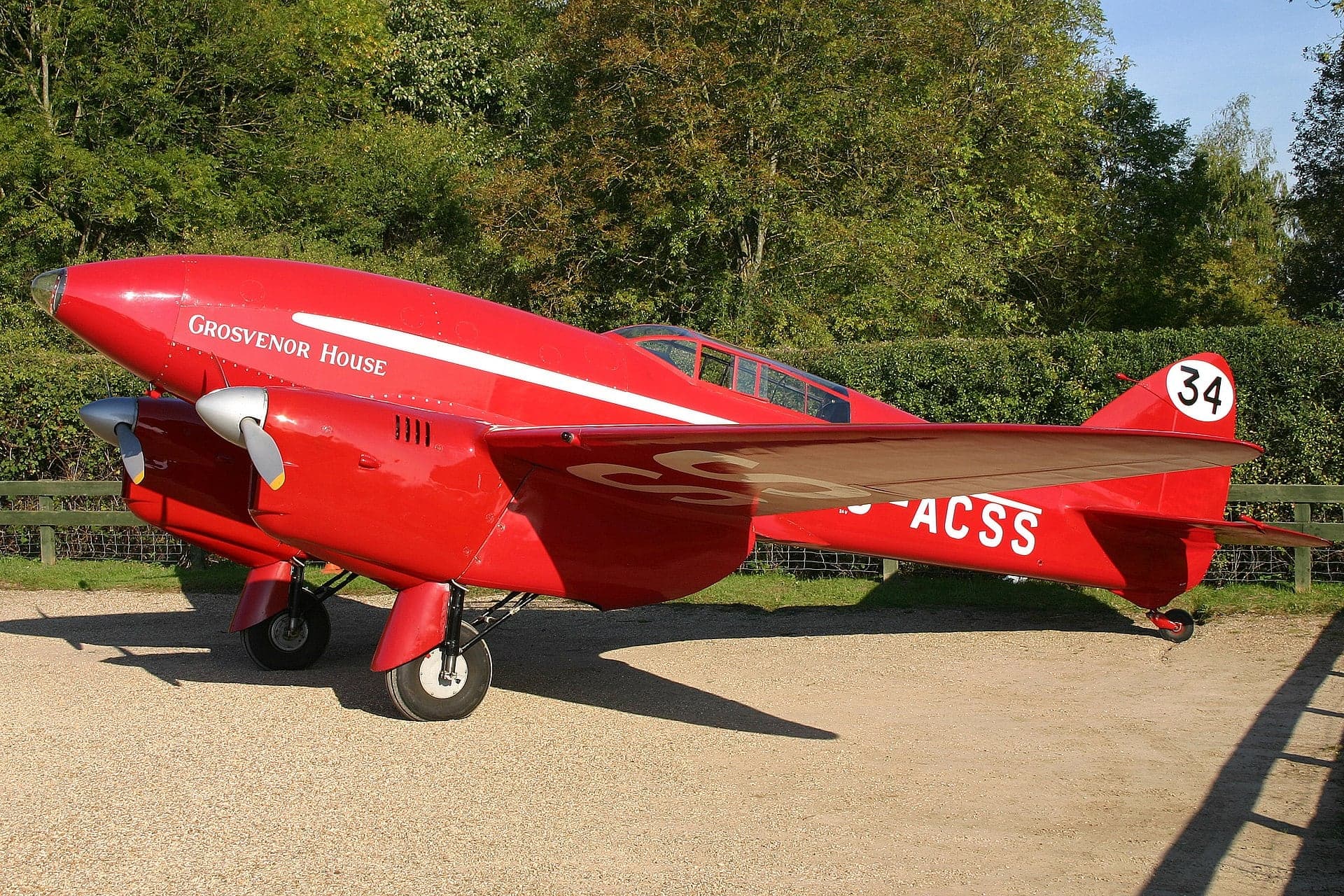 The restored red DH.88 Comet G-ACSS 'Grosvenor House' parked on the grass at Old Warden