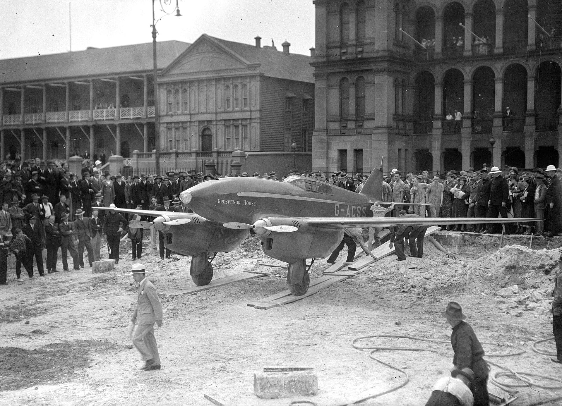 The red DH.88 Comet 'Grosvenor House' surrounded by crowds in Martin Place, Sydney, in November 1934 after winning the race to Melbourne