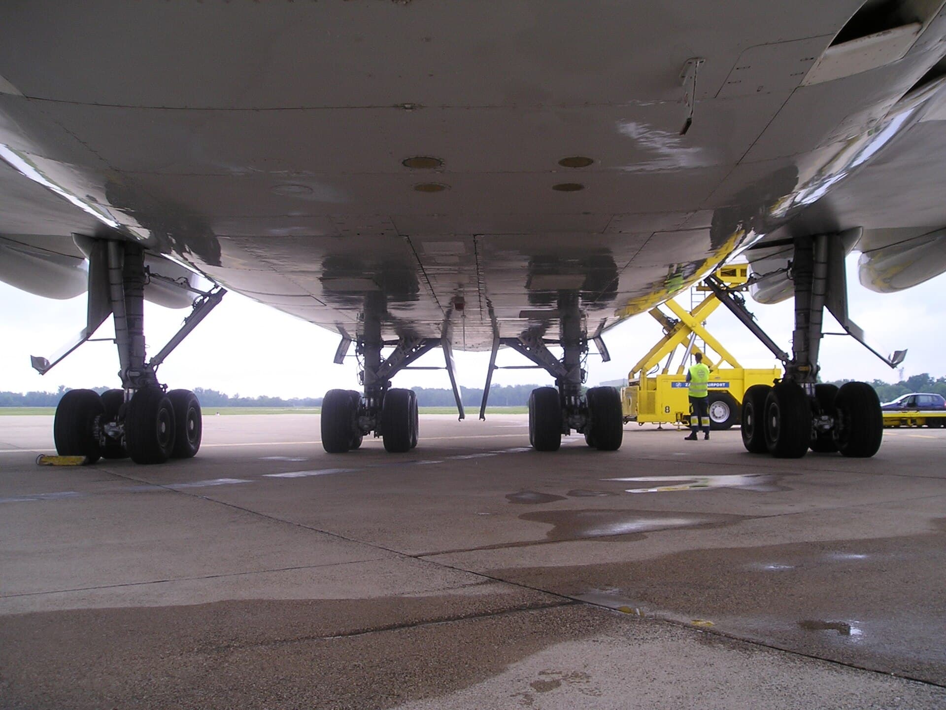 The four main landing-gear bogies of a Boeing 747 seen from below, each carrying four wheels to spread the aircraft's weight over airport pavement