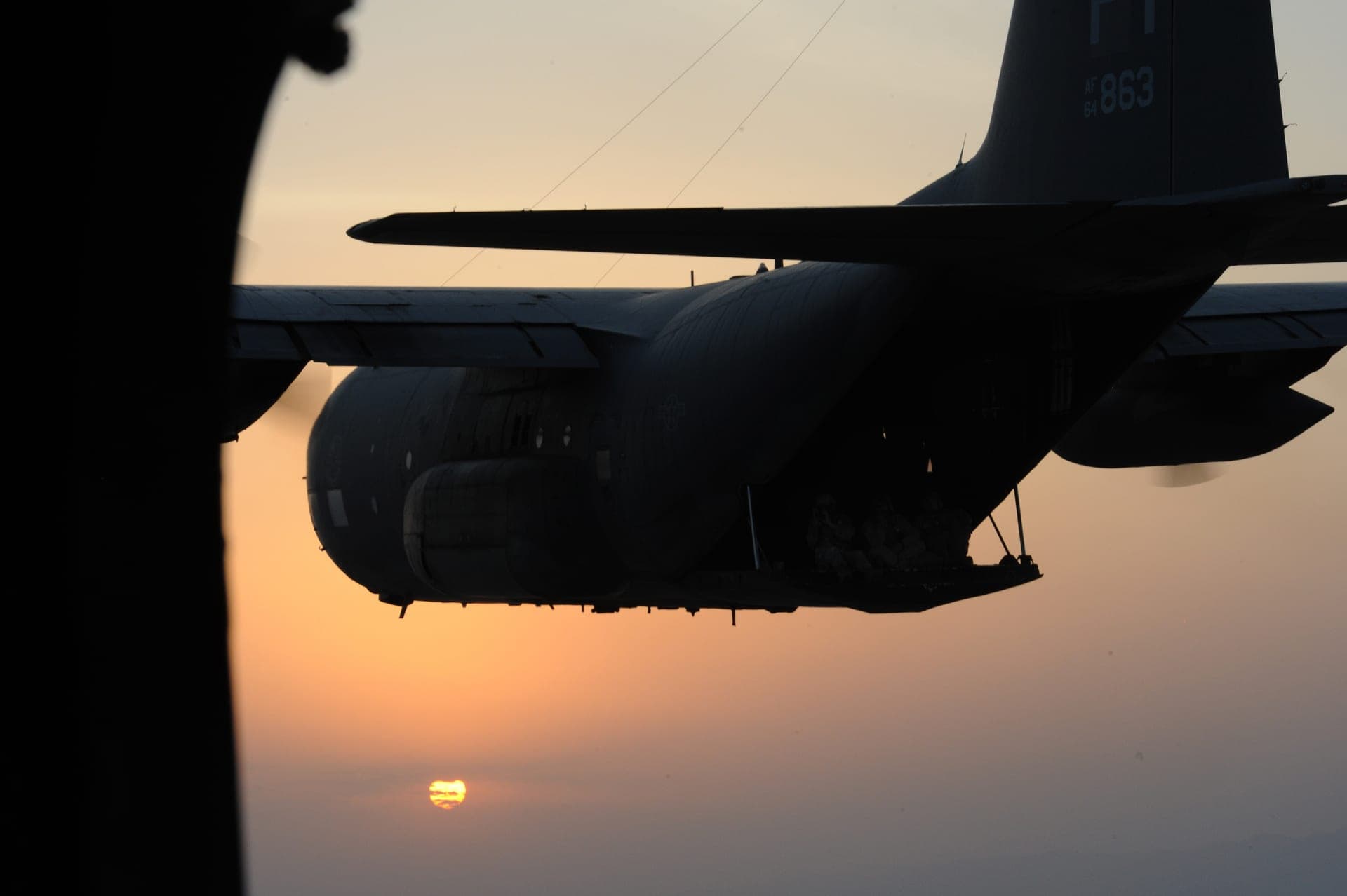 An HC-130P Combat King prepares to refuel a CH-53E Super Stallion helicopter over the coast of Djibouti, 2012